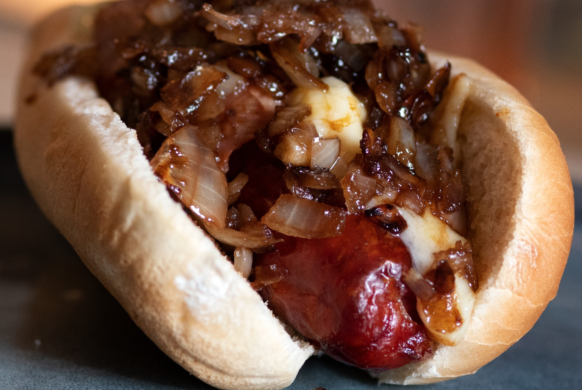 Hot dog with caramelised onions and cheese