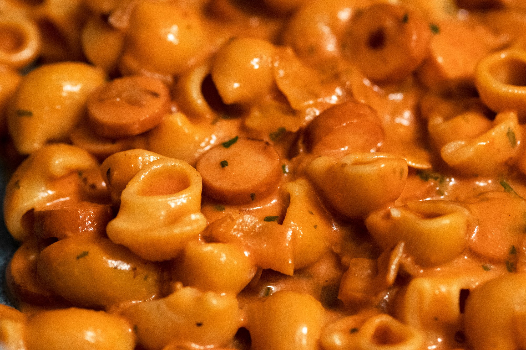 Pasta with sliced hot dogs in a tomato sauce