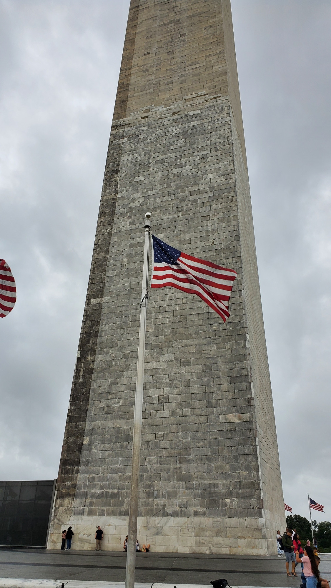 An American flag waves in the breeze before the Washington Monument.