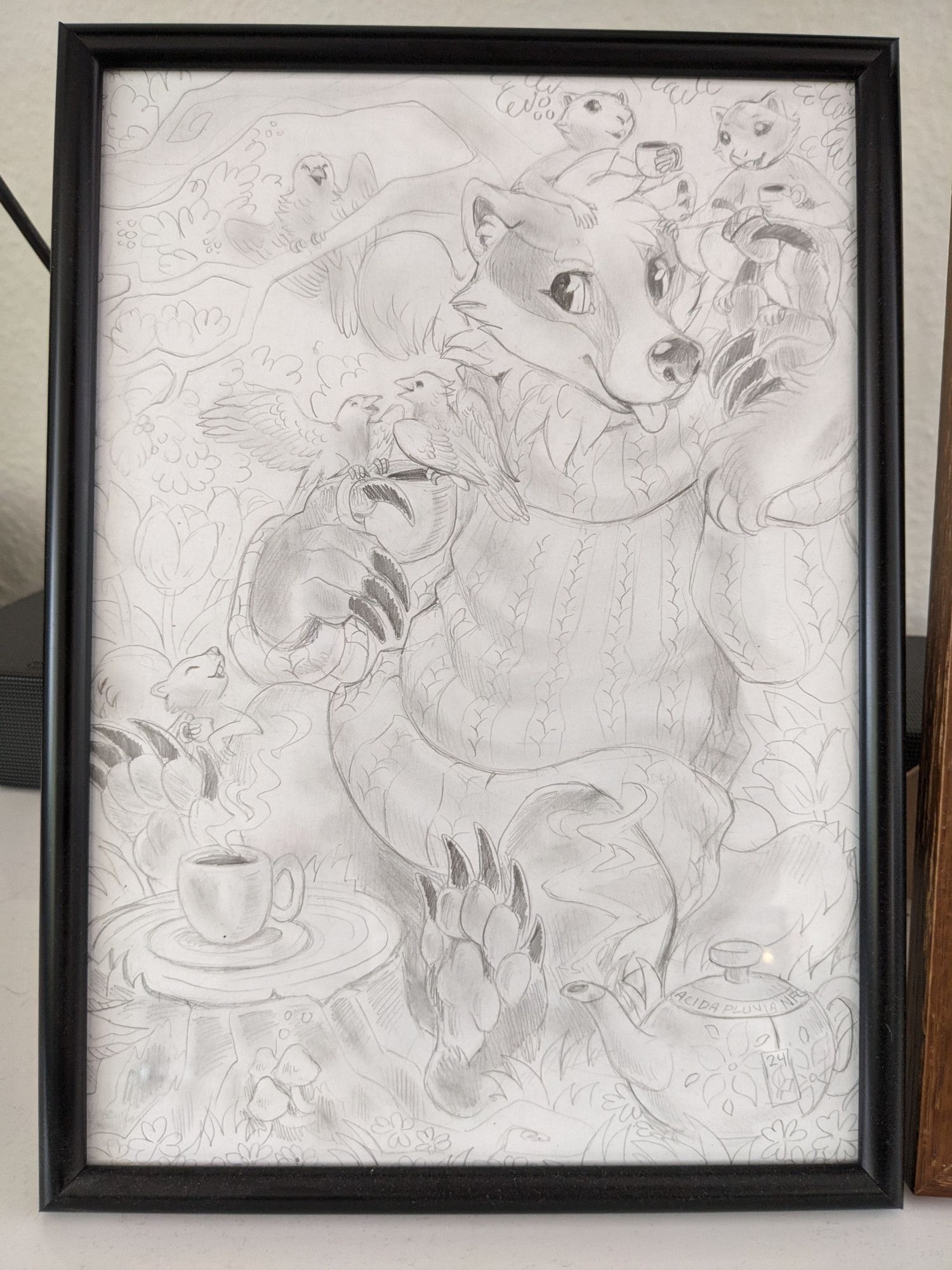 Framed pencil drawing of Bramble the badger sitting in front of a tree trunk with a cup of tea on it, surrounded by little squirrels and birds holding similarly tiny cups