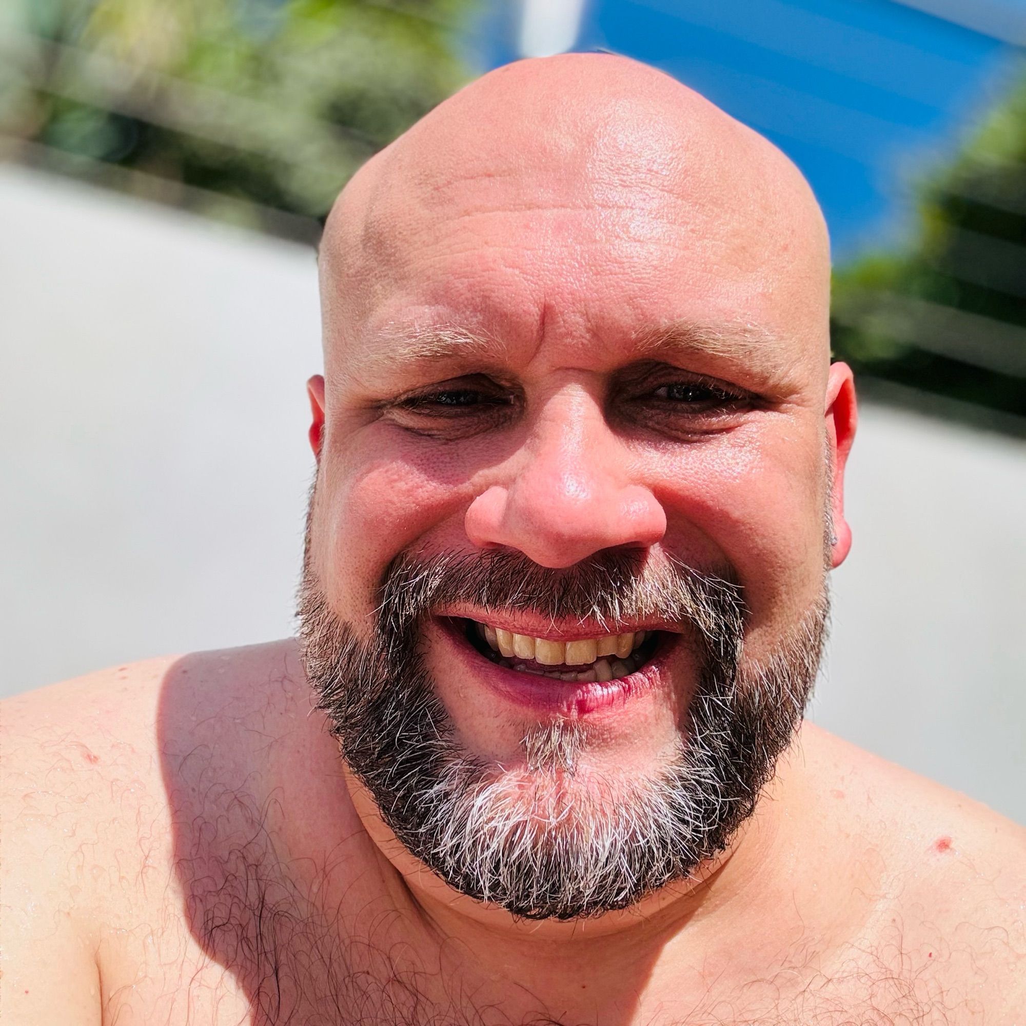 A selfie of Rich smiling as he soaks up the sun