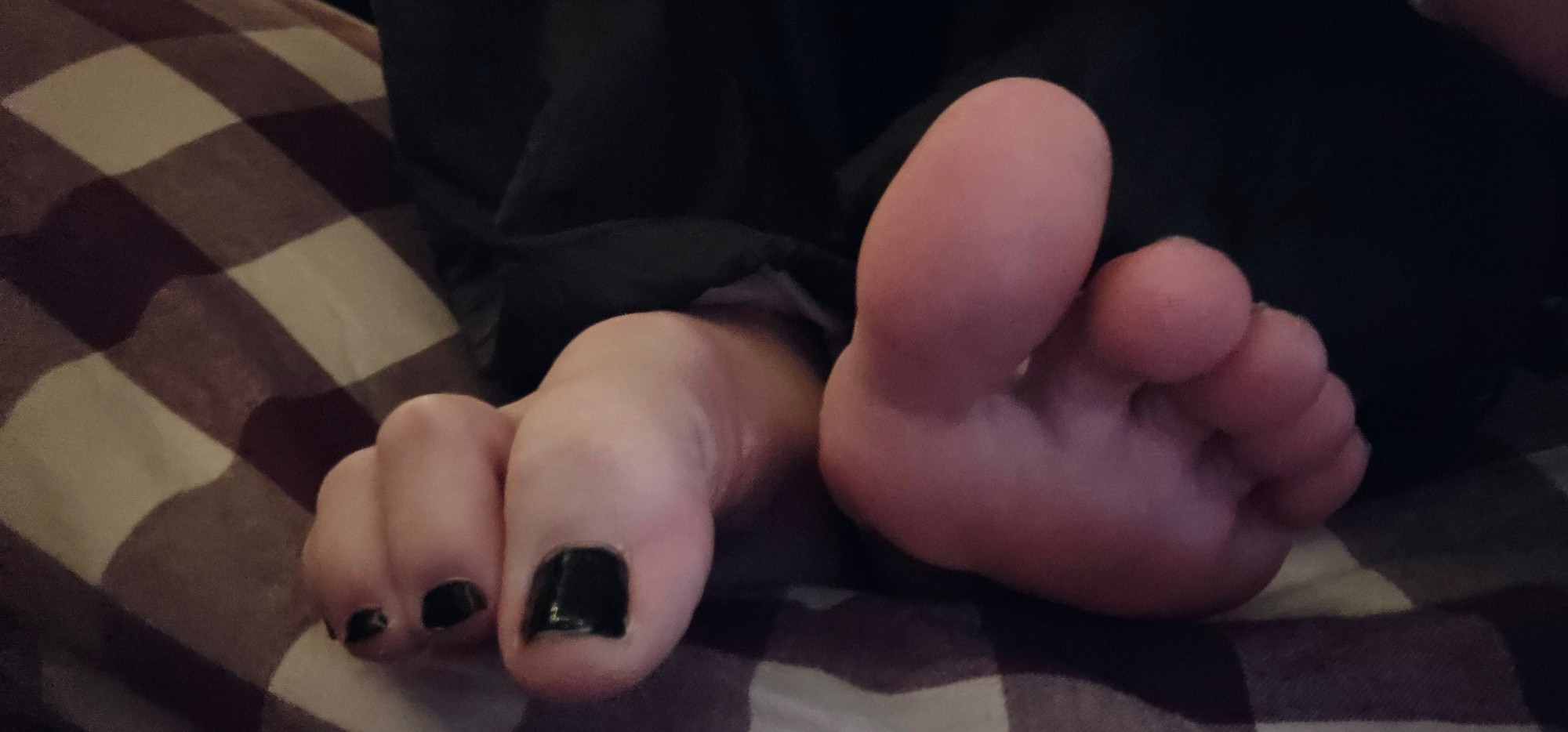 just a fun dumb lil photo I took last month of my feet n toes and my toenails are painted black I believe