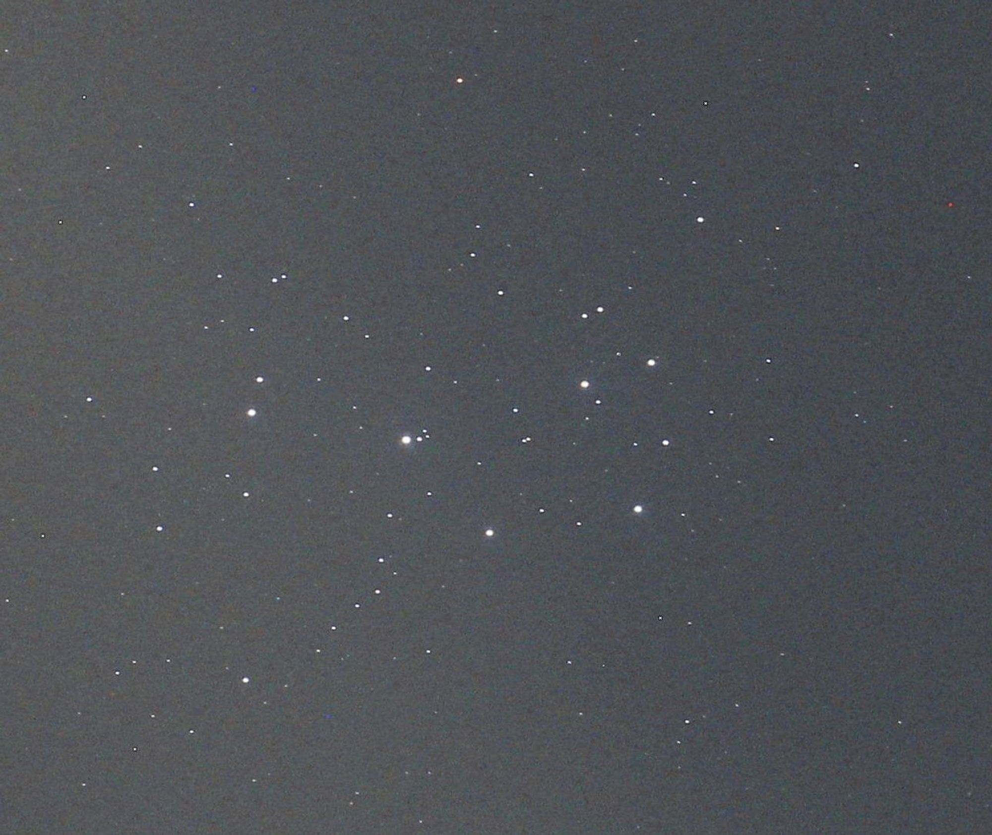 The Pleiades star cluster consisting of bright dots at centre.