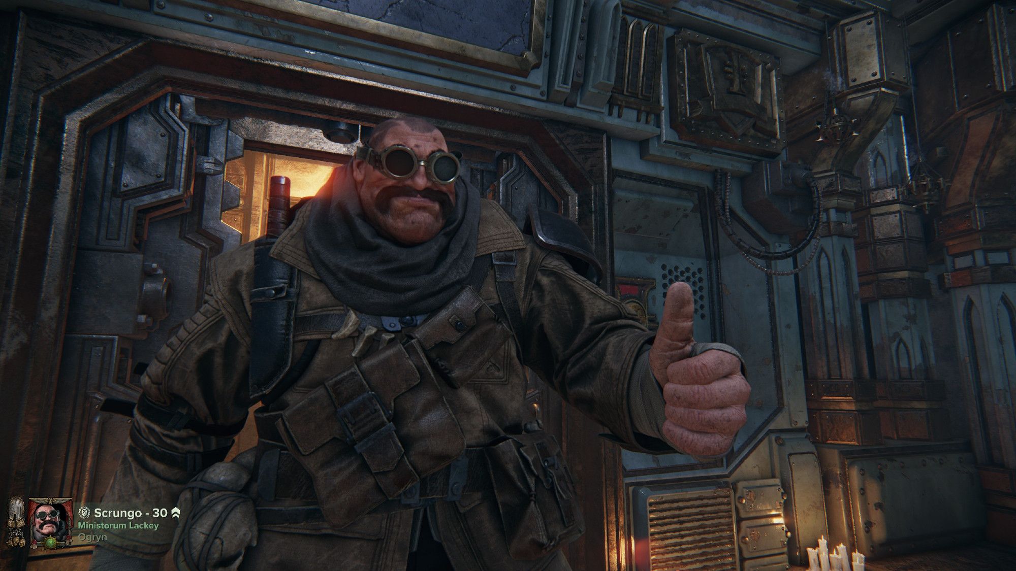 A large Ogryn with goggles and a large overcoat. He is giving a thumbs up.