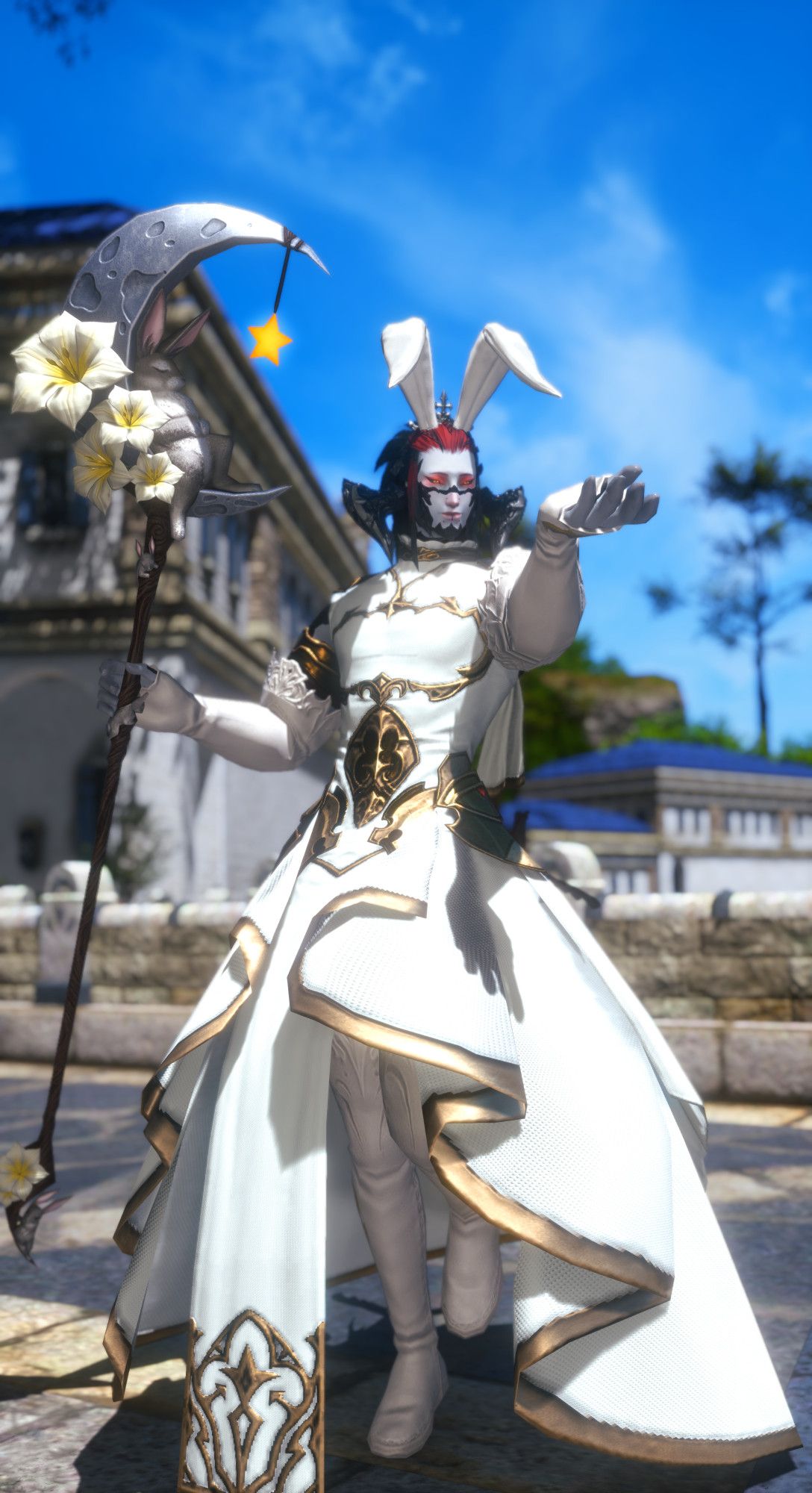 Male Au Ra with a gentle smile presenting an empty hand while holding a staff depicting a bunny sleeping on the Moon. He is wearing a long, flowing pure white robe with gold trims, pure white long-sleeve gloves and thighboots and a small crown with floppy bunny ears