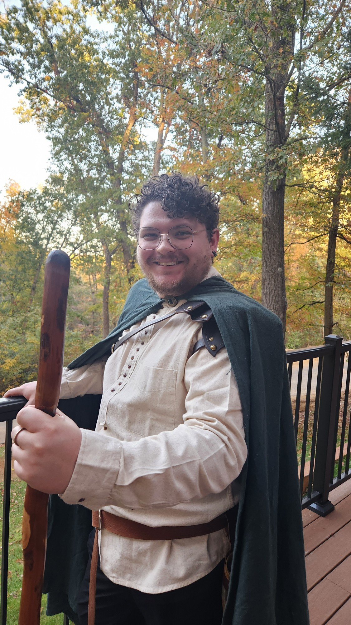 Me at the Castle wedding in medieval dress. Green cape, white linen shirt, wooden staff.