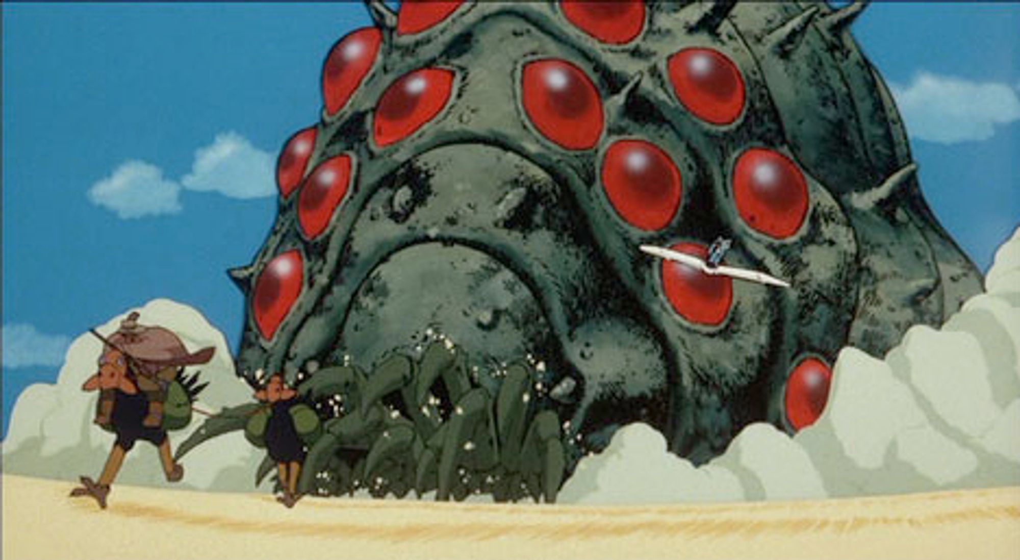 A giant Ohmu from the movie Nausicaä of the Valley of the Wind. The sky behind is blue with errant white clouds. It's running on sand. It's shell is muted green-gray, abut the whole scene is dominated by its numerous, radiant red eyes, spread in two belts of armor midway towards its tallest point on its curved body. A couple runner birds, one carrying a human rider, are just barely ahead of it, running for their lives, as the Ohmu is effectively an unstoppable force for anything at human scale - the ohmu itself towers like a large building.