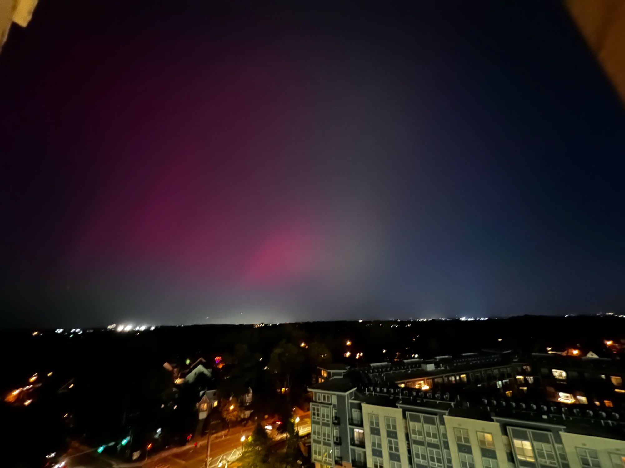 Sky with pink haze of aurora borealis, Silver Spring, MD. 12th-floor balcony.