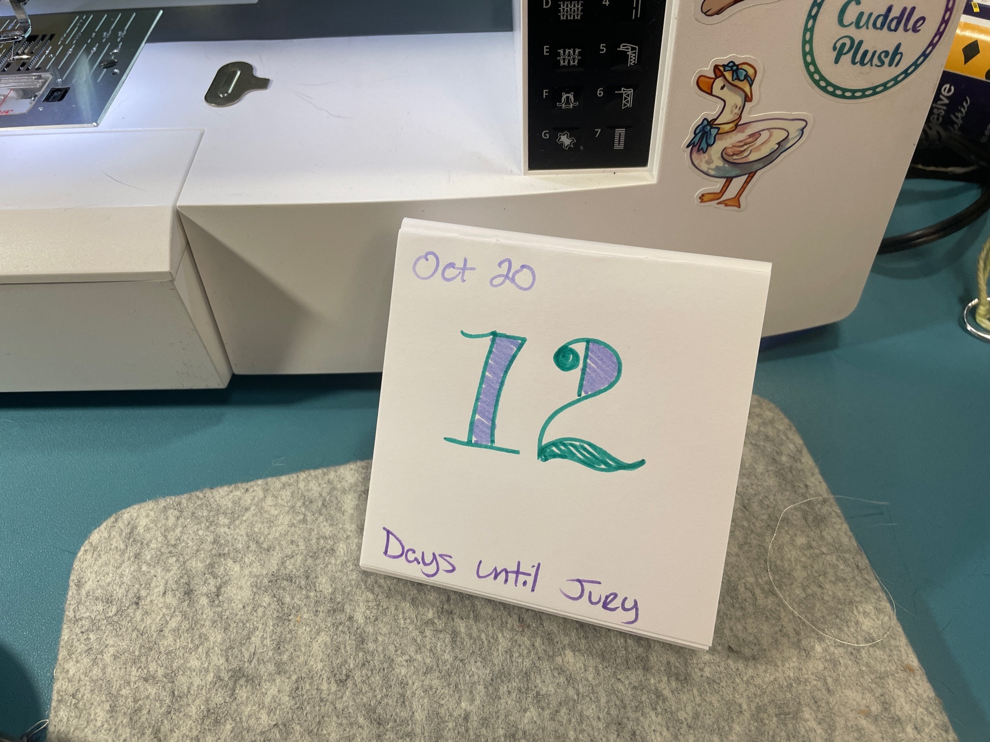 My countdown calendar in front of my sewing machine. The text reads “Oct 20: 12 days until jury”