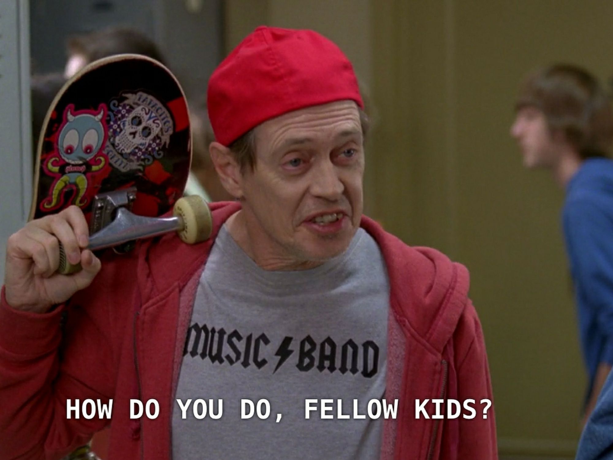 Steve Buscemi approaches a group of highschoolers dressed in a hoodie and carrying a skateboard saying "how do you do fellow kids?"