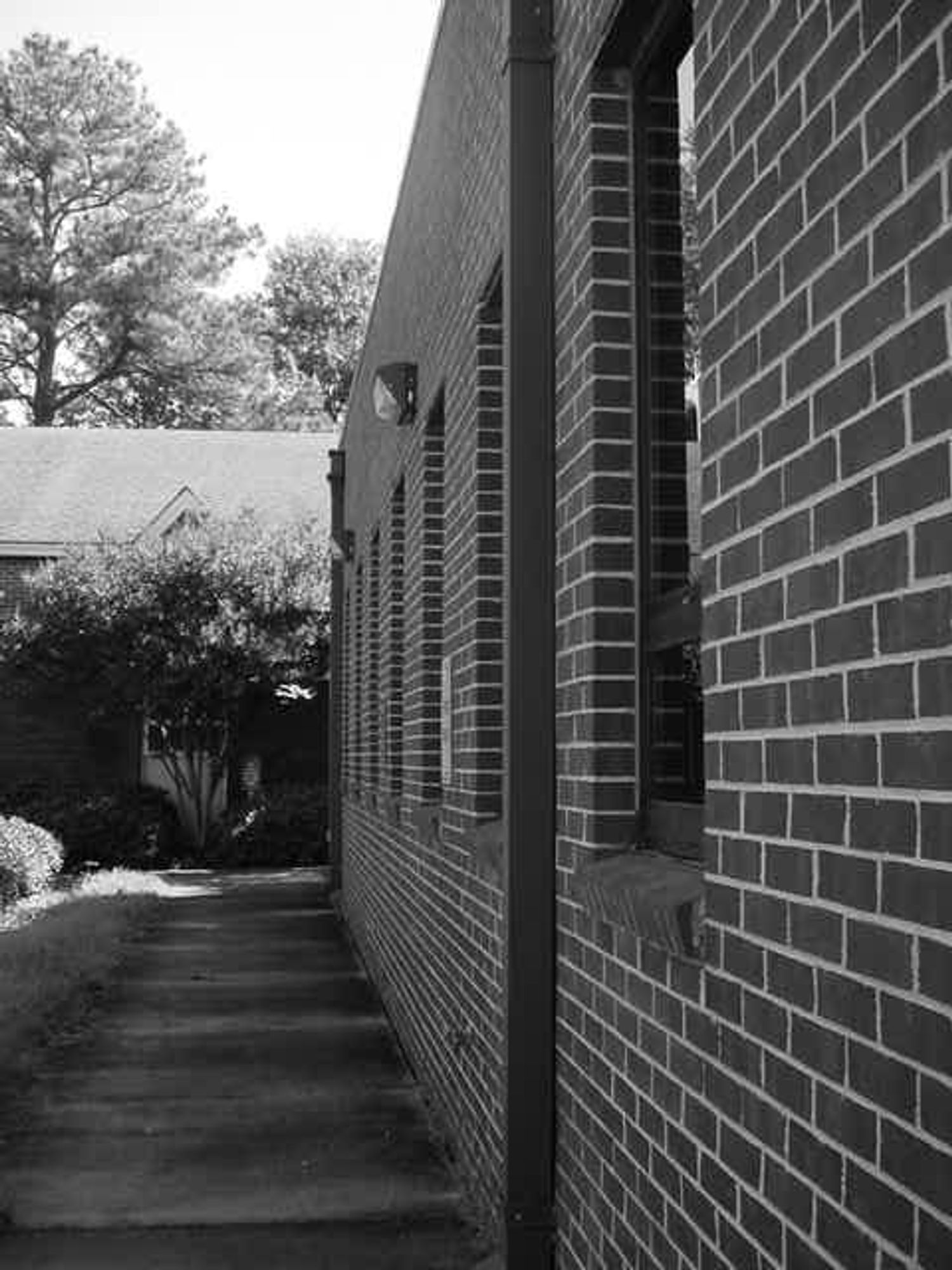 A brick wall with windows. This was taken with the black and white setting on a Sony Mavica MVC-FD200, the infamous floppy disk camera.