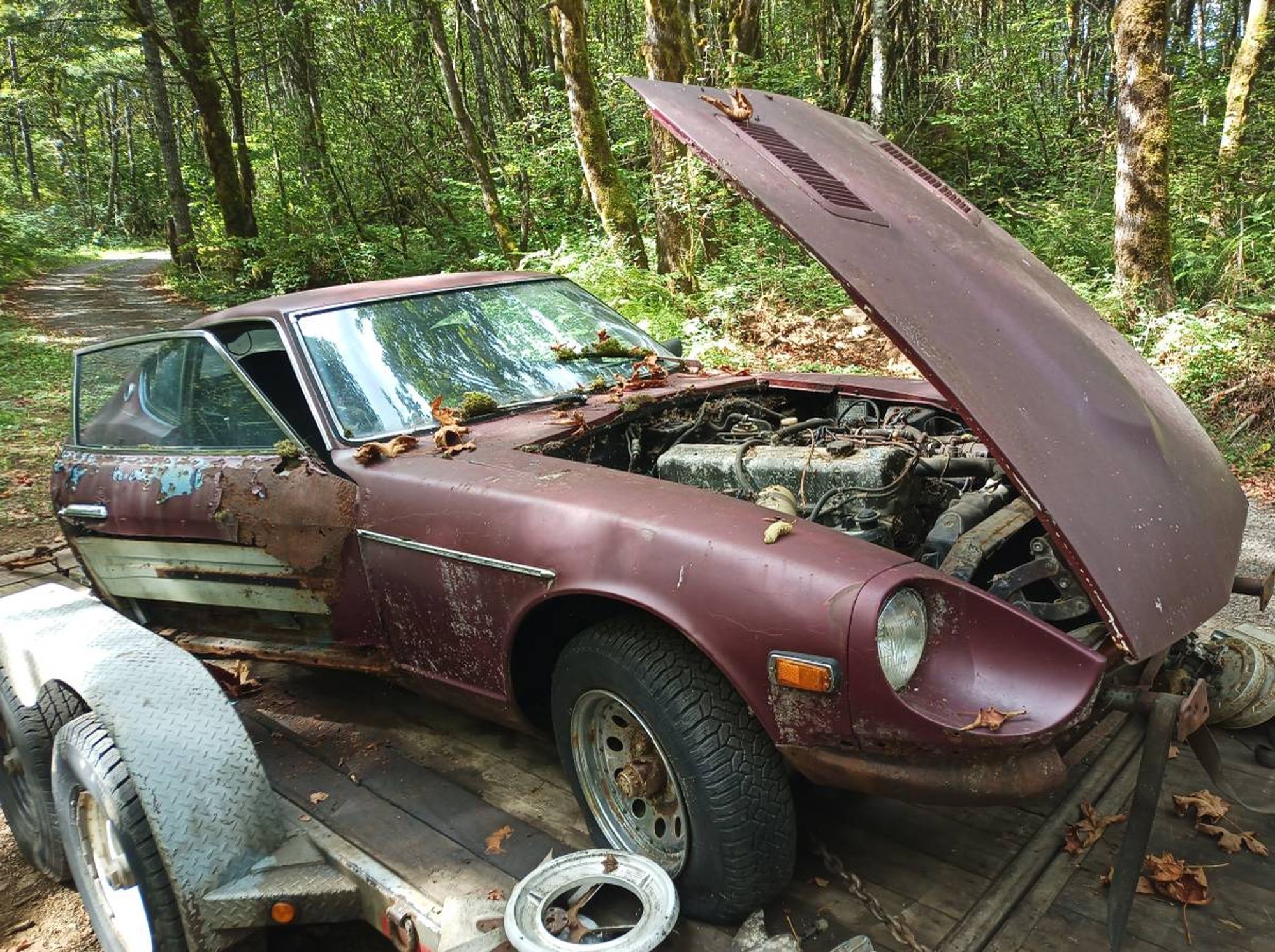 A brown Nissan 280 Z on a trailer