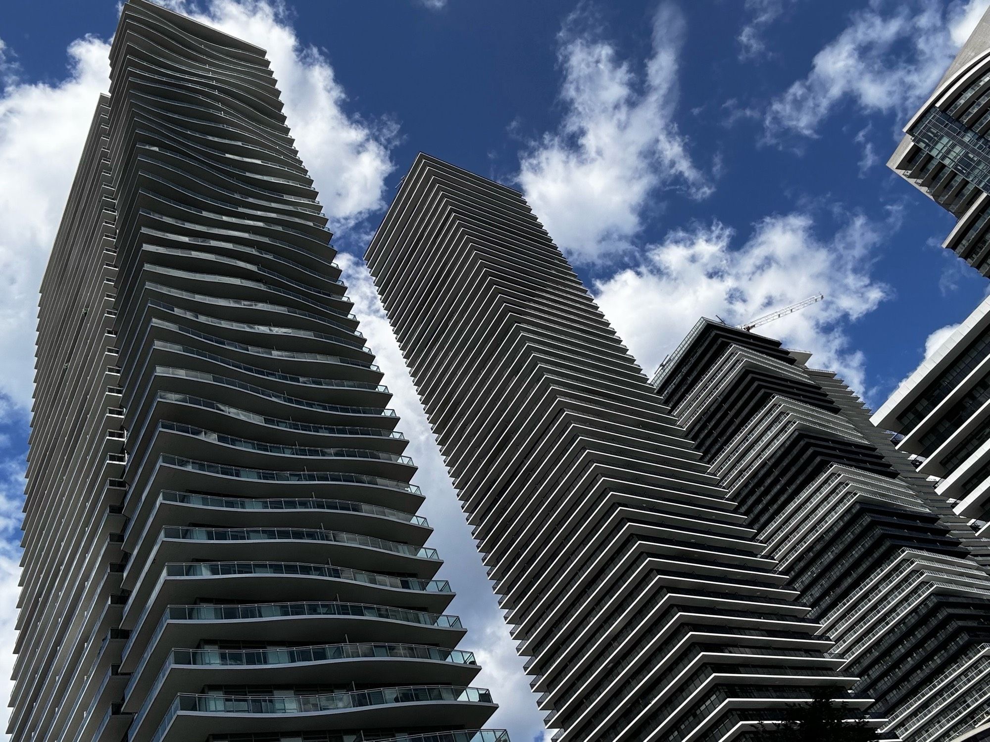 High rise buildings against the cloud-pocked blue sky