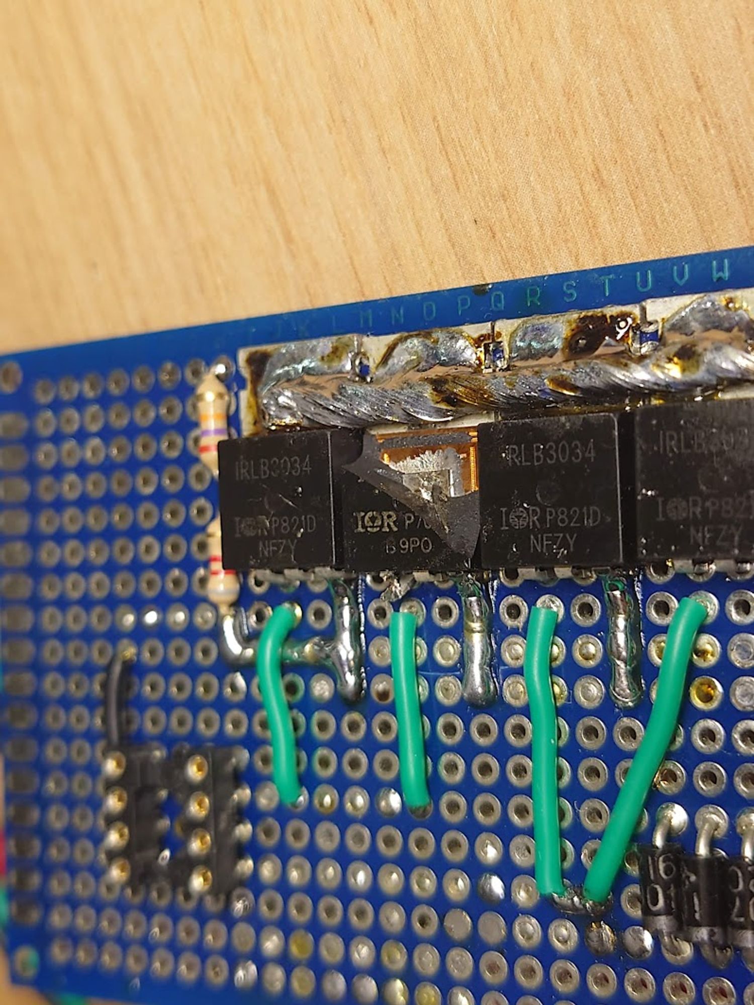 A PCB with multiple Mosfets next to each other. One of them exploded and is missing its housing.