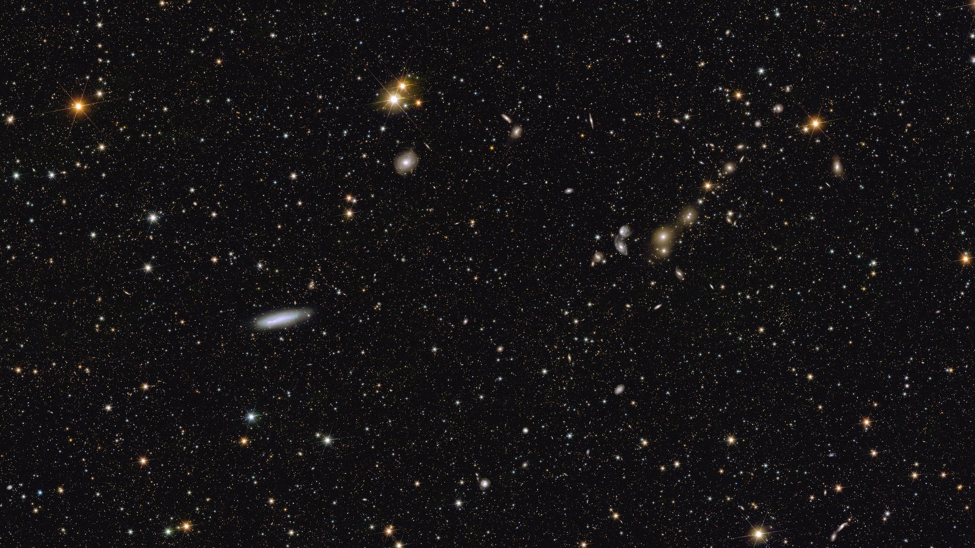 This image shows an area of the mosaic released by ESA’s Euclid space telescope on 15 October 2024. The area is zoomed in twelve times compared to the large mosaic. In the middle left, spiral galaxy NGC 2188 is visible edge-on at a distance of 25 million light-years. In the top right corner, galaxy cluster Abell 3381 is now clearly noticeable, 678 million light-years away from us.