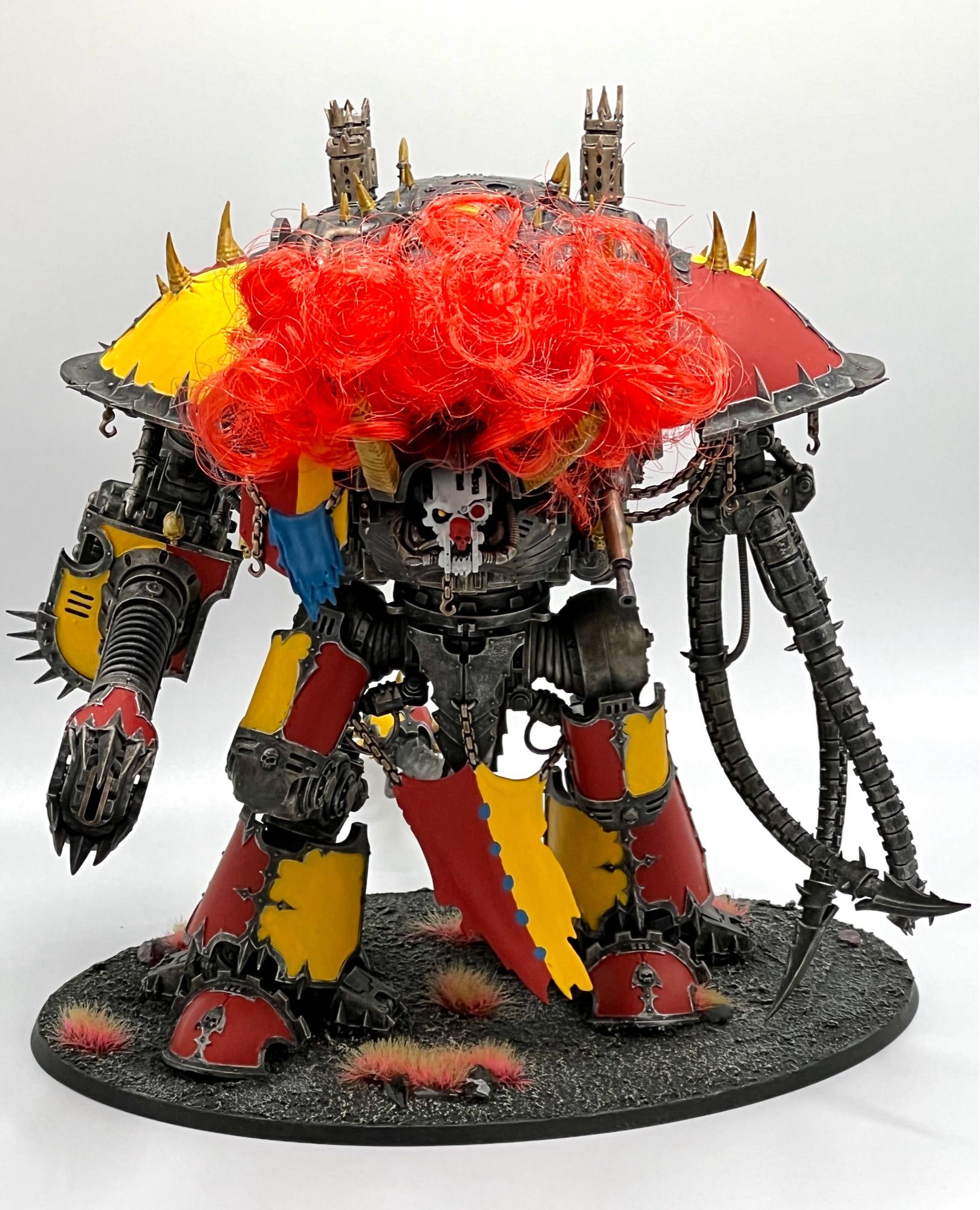 Chaos knight Abominant painted in a red and yellow clown scheme with a big red clown wig.