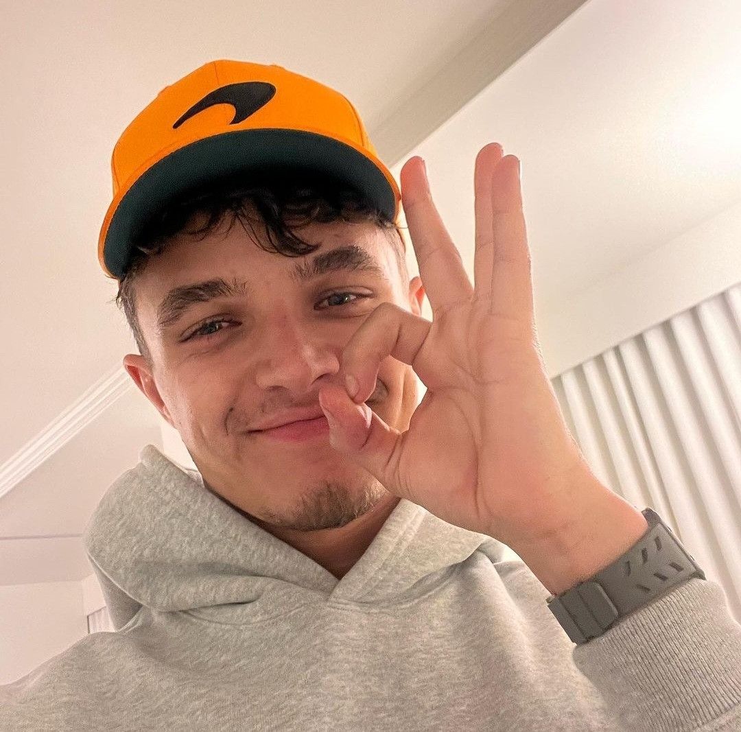 Lando Norris making a sign with his Hand signalling he is okay