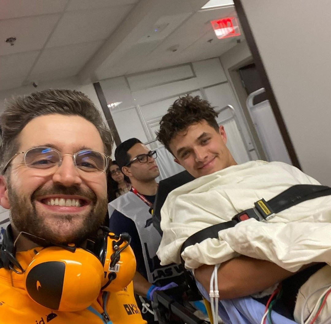 Lando Norris getting transferred to the hospital, but smiling