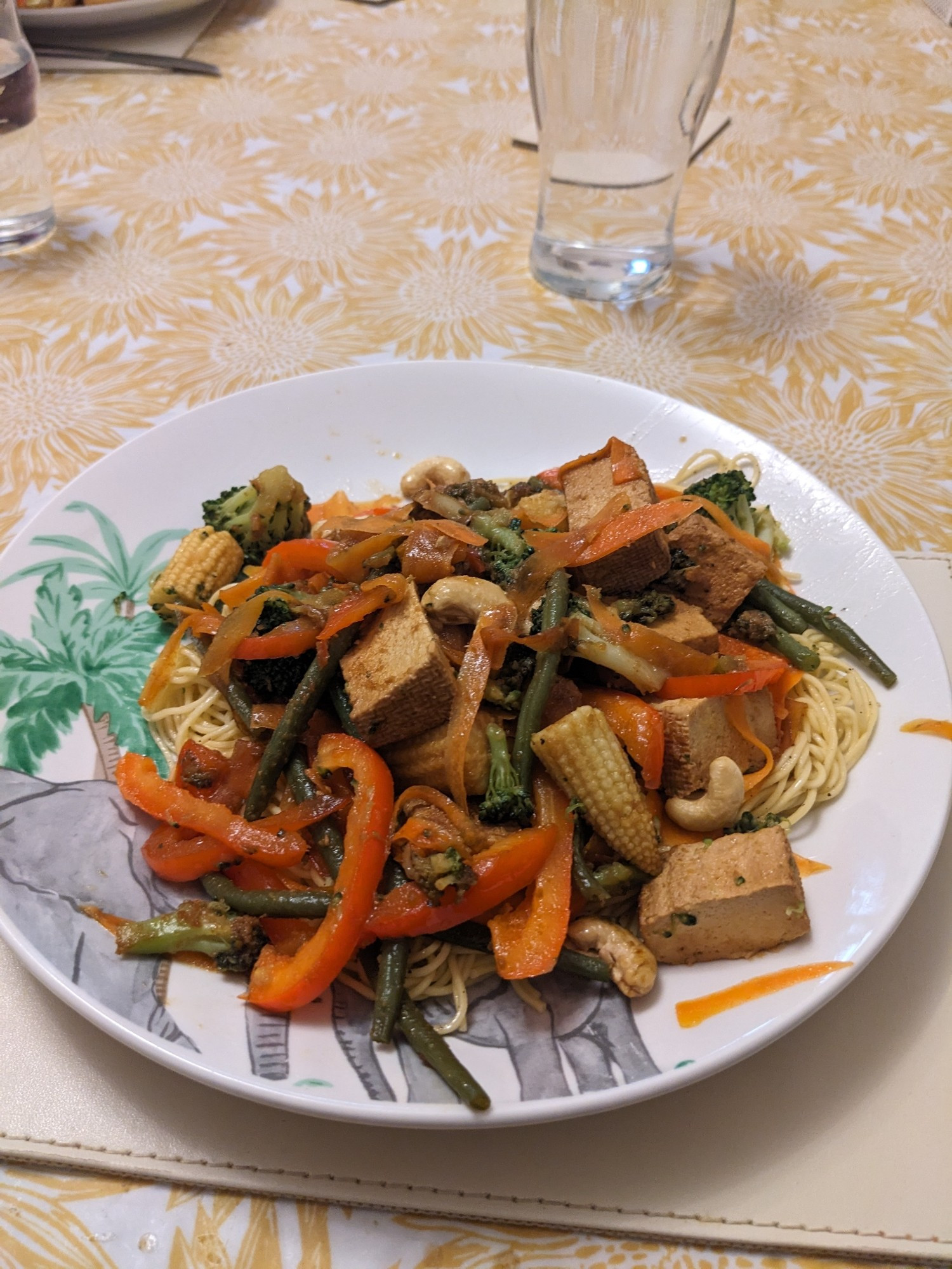 Homemade tofu chow mein and noodles. Featuring carrots, broccoli, cashew, baby corn, peppers, onions and green beans.