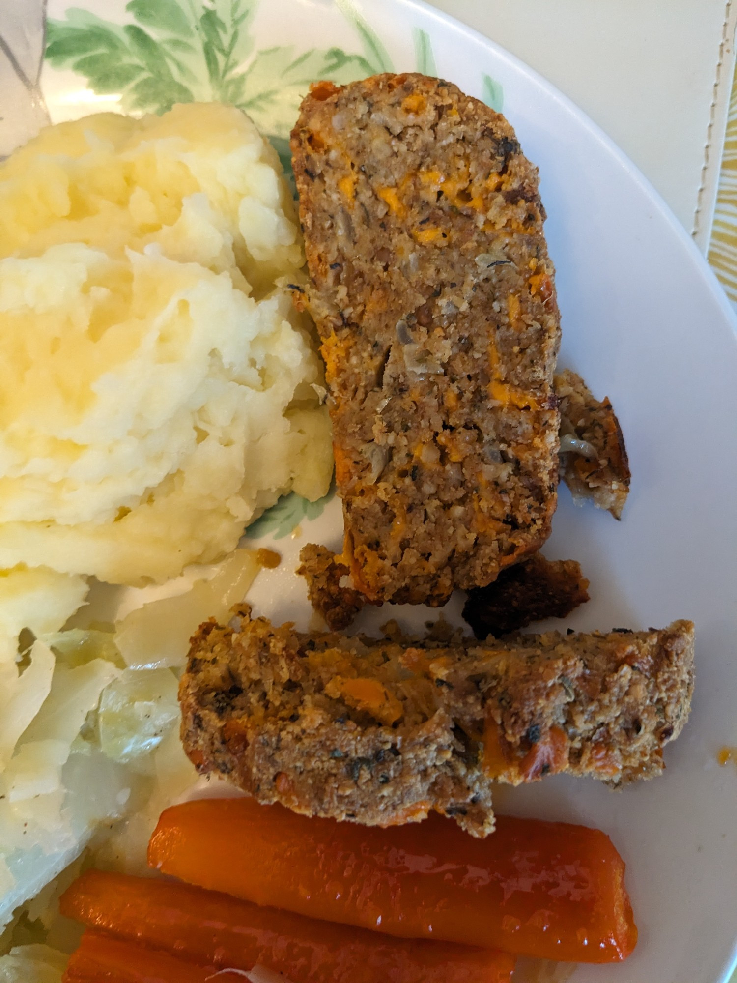 Nut roast, served alongside mashed potatoes, cabbage and honeyed carrots.