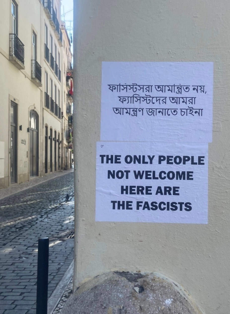 Posters in English and Bengali on a wall that says that Fascists are not welcome