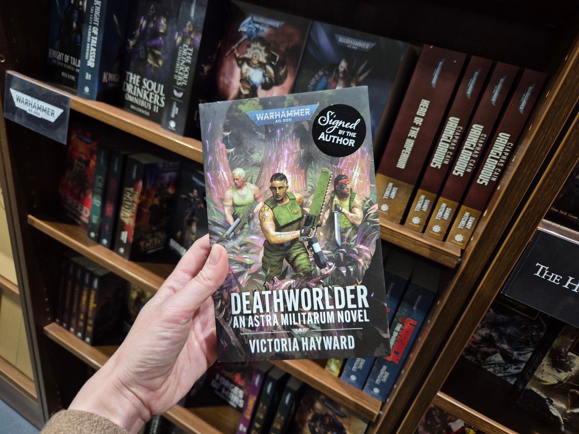 A copy of Deathworlder with a 'signed by the author sticker'