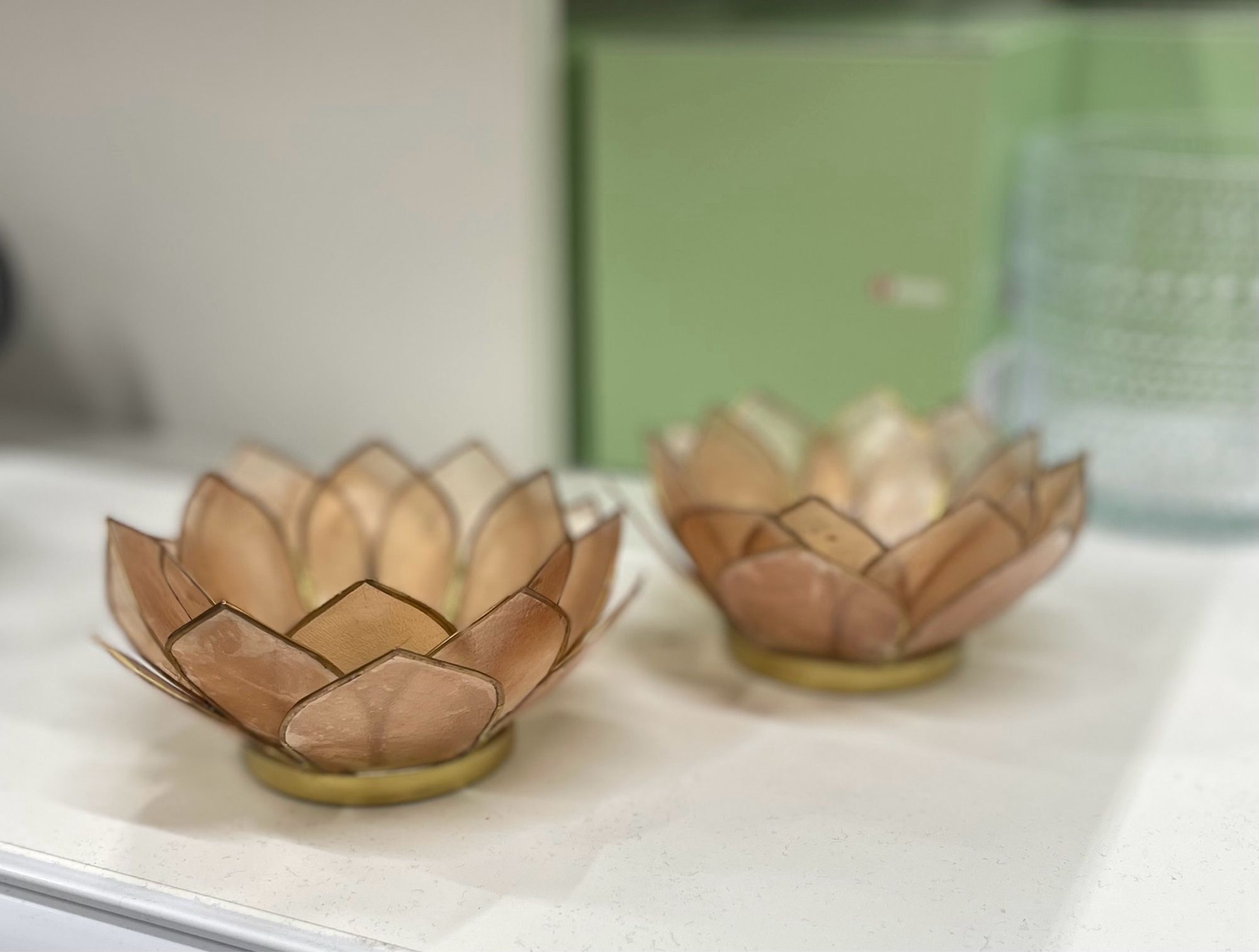 Two brown-ish candle cups in a shape of lotus flower