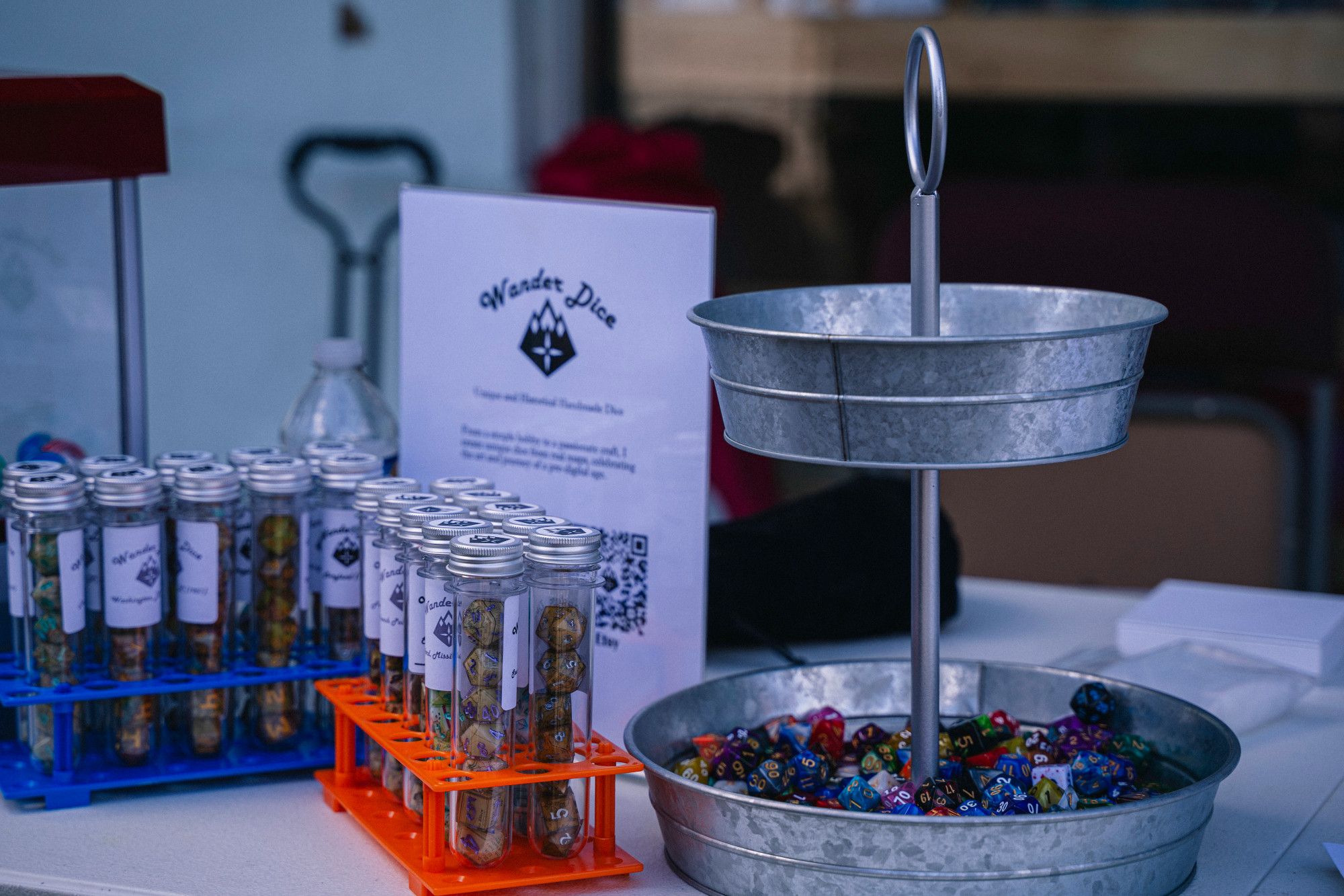 "Test tubes" of dice in front of a "Wander Dice" sign.