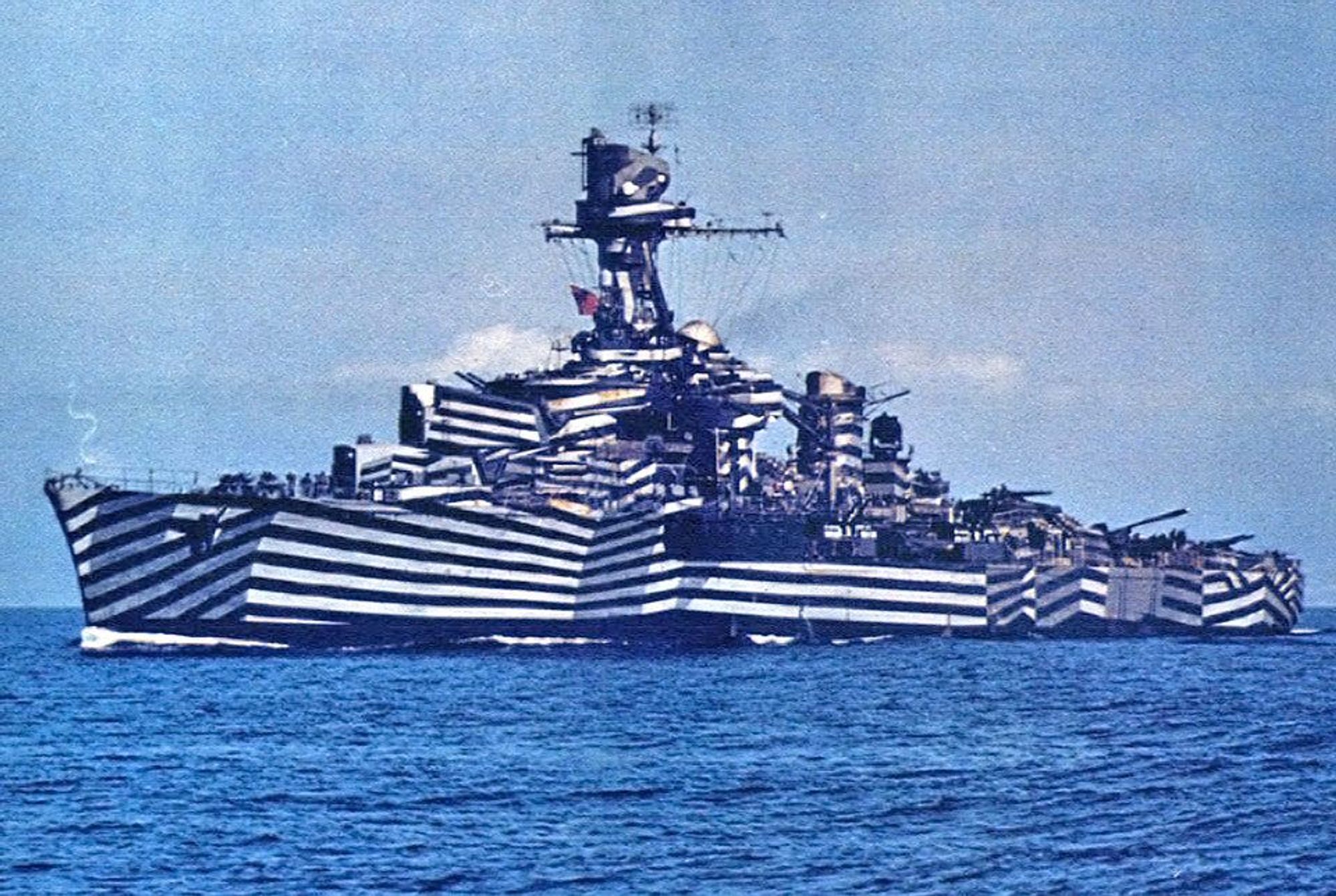 A warship decorated in eye-popping black and white stripes