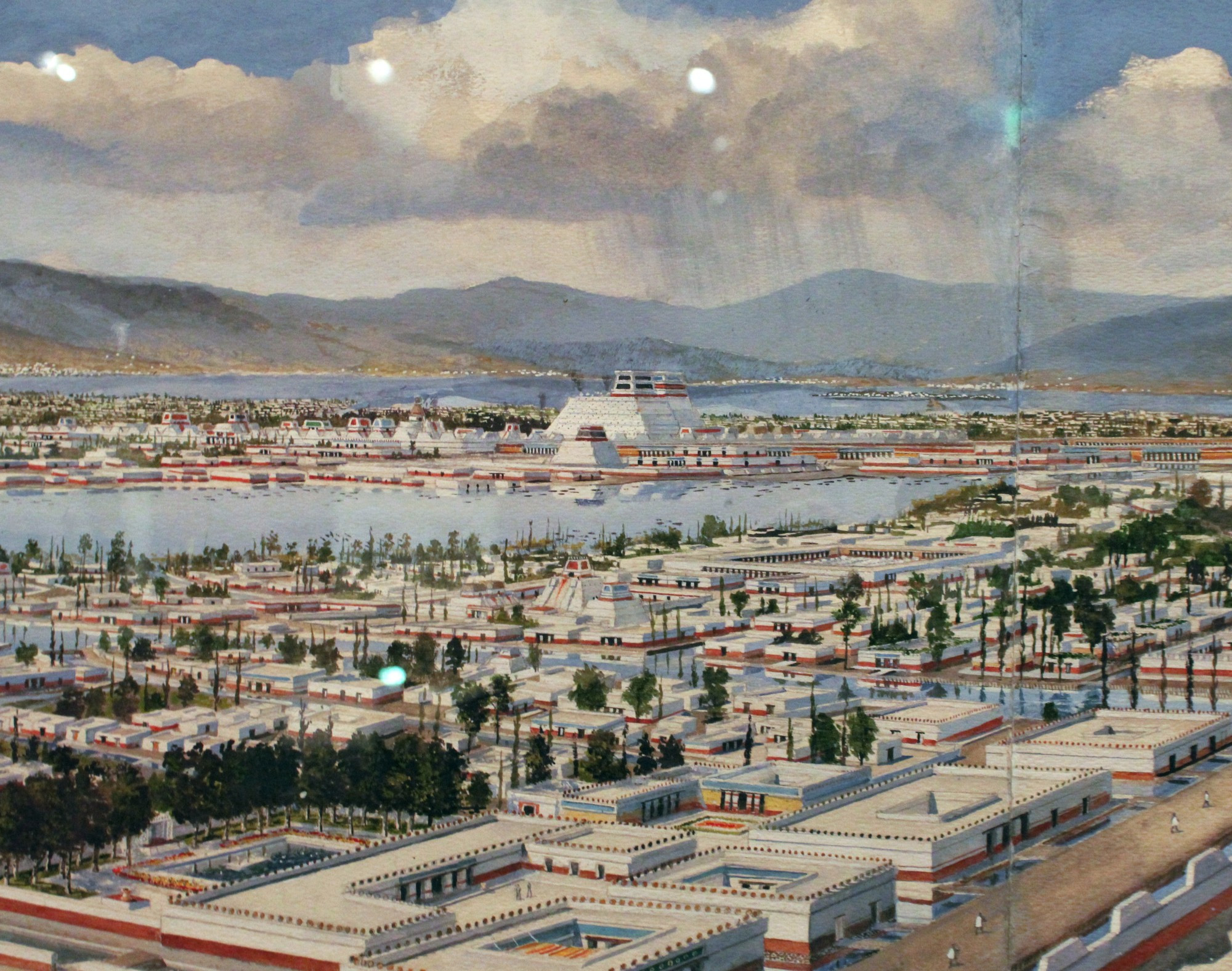 Partial detail photo (taken by me at the "Imagined Realism" exhibit) of "Distant view of Tlatelolco" painting by Scott and Stuart Gentling/Rights managed by the Amon Carter Museum

The painting depicts a wide vista view of the Aztec capital of Tenochtitlan as seen looking North from the summit of the city's Great Temple, with the central precinct of Tlatelolco (technically a separate city Tenochtitlan physically absorbed as a de facto fifth city quarter) visible in the distance, which is what is seen in the frame of my photo here in the background. 

Inexact cropping, downscaling, and color correction applied to the photo... while I am normally fine with people reusing my photos, this specific photo depicts art still in Copyright, so refer to the Amon Carter museum for  rights or use/repost at your own risk.