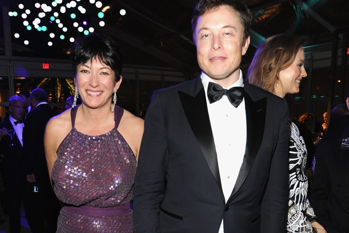 Tesla CEO Elon Musk and Ghislaine Maxwell at the 2014 Vanity Fair Oscars afterparty standing side by side in evening wear. Ghislaine is wearing a purple sequined dress and smiling broadly. Elon is wearing a tuxedo and also smiling.