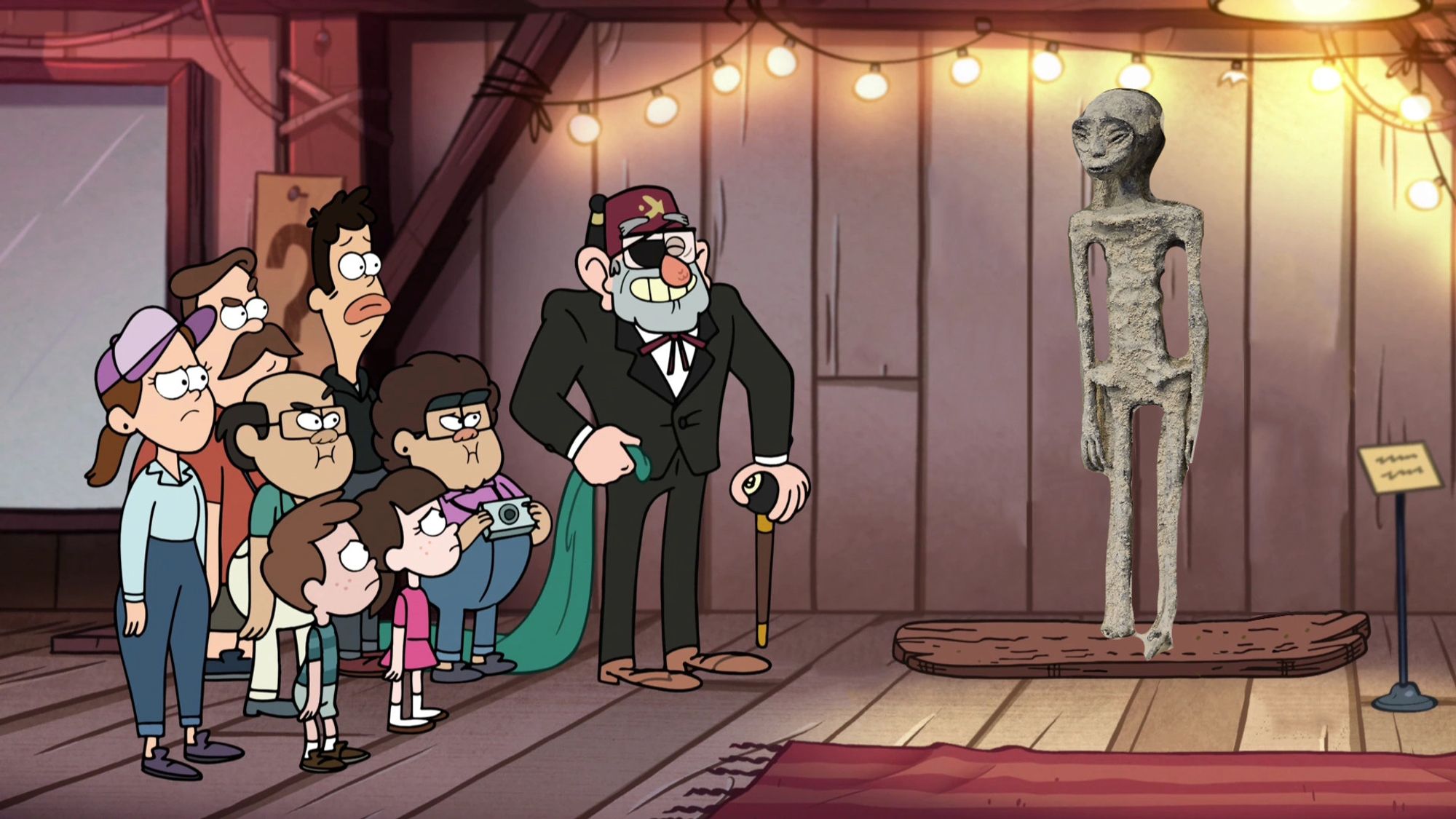 Stan Pines from Gravity Falls shows off the hoax alien body inside the Mystery Shack to a crowd of disappointed tourists.