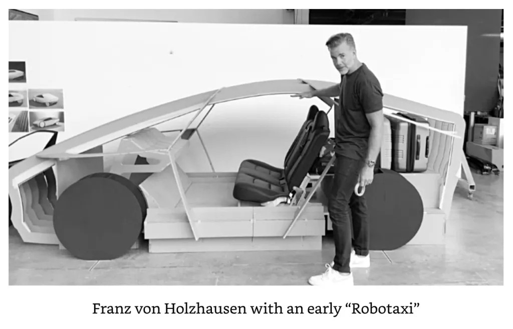 A wooden styling buck of the Tesla "robotaxi" with chief designer Franz von Holzhausen, showing how tiny and low to the ground this absurd little vehicle is. Entering and exiting look like they take sporstcar level contortions, and the tiny hatch barely fits two medium sized suitcases. No taxi has ever looked like this, for reasons immediately obvious to anyone who has ever actually ridden in a taxi.