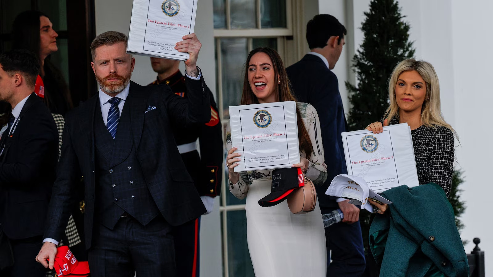DC Draino, Chaia Raichik, and Liz Wheeler holding binders labeled "Epstein Files: Phase One"