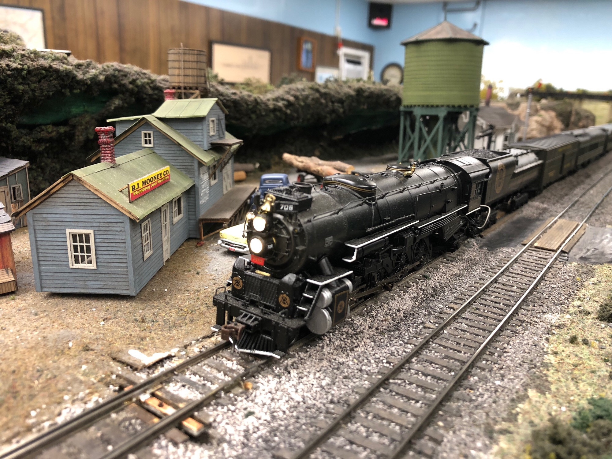 A photo of a Superpower steam locomotive: an HO scale Bachmann heavy 4-8-2 mountain type locomotive as it would have appeared in the late 1940s or mid 1950s at the apex of steam: with twin air pumps, front end throttle, feedwater heater, and other modern appliances