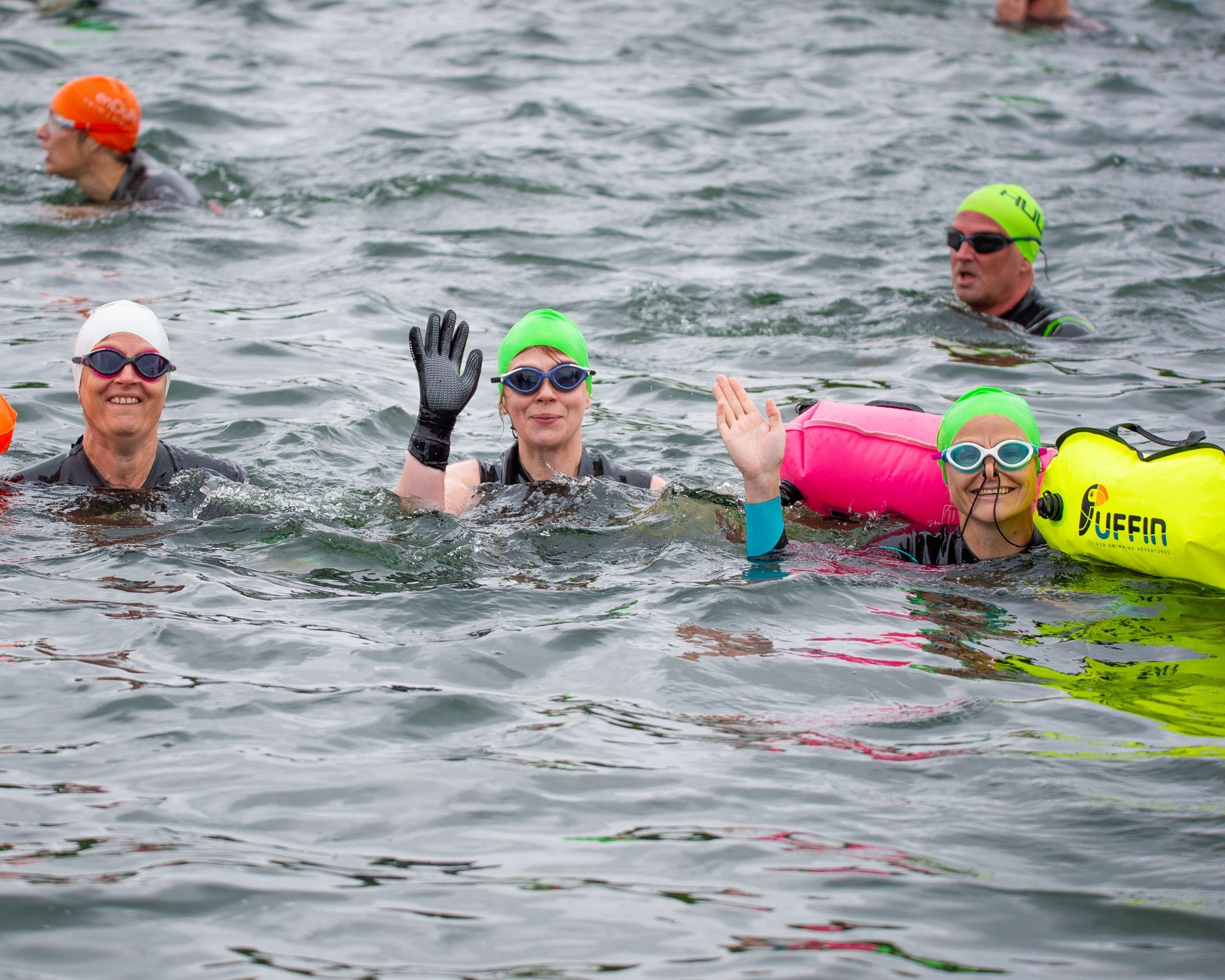 Swimmers in a lake at the start of an open water swimming event