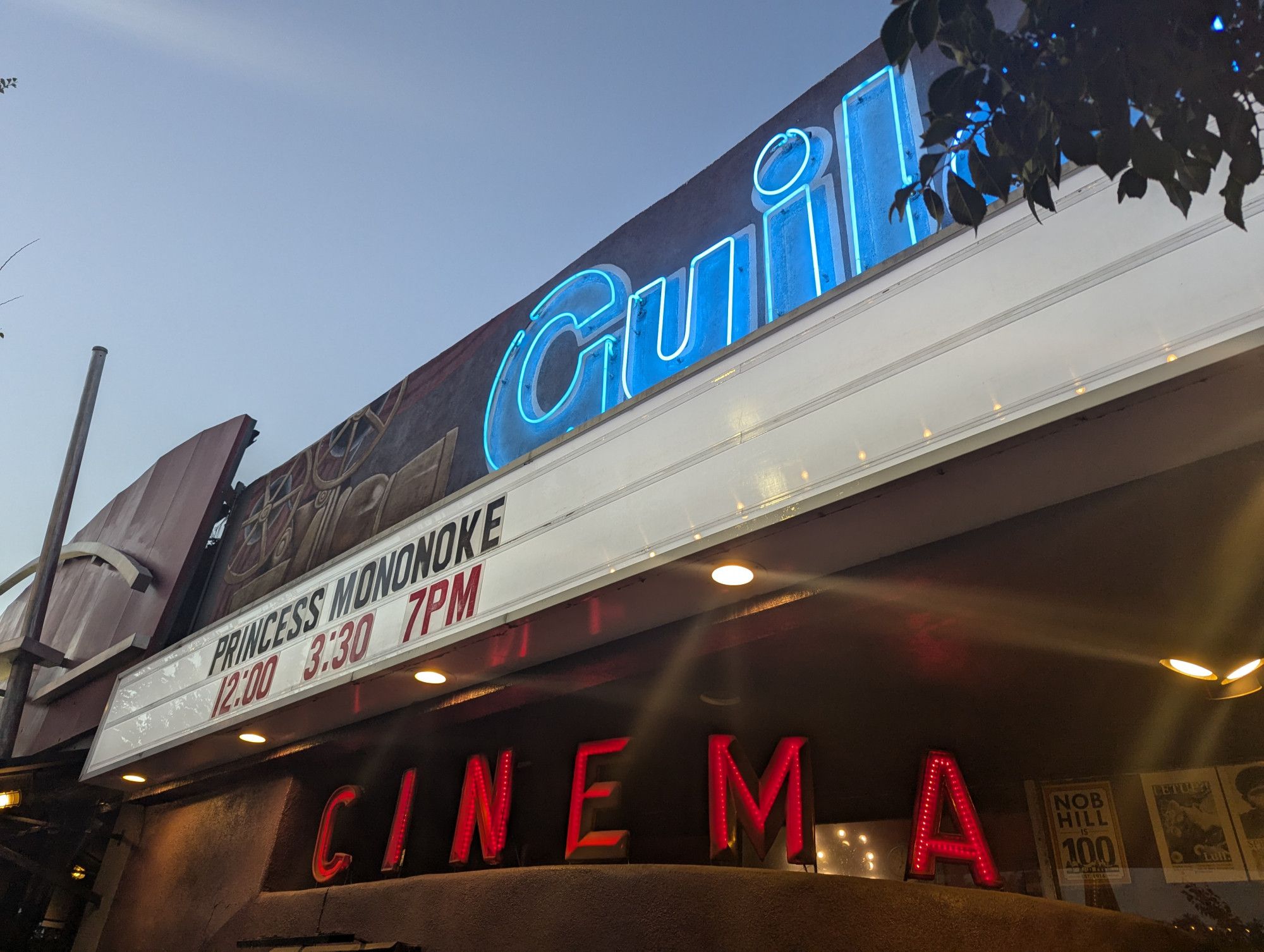 Picture of the neon signs of the Guild Cinema. on the marquee it shows that Princess Mononoke is playing at 12, 3:30 and 7pm