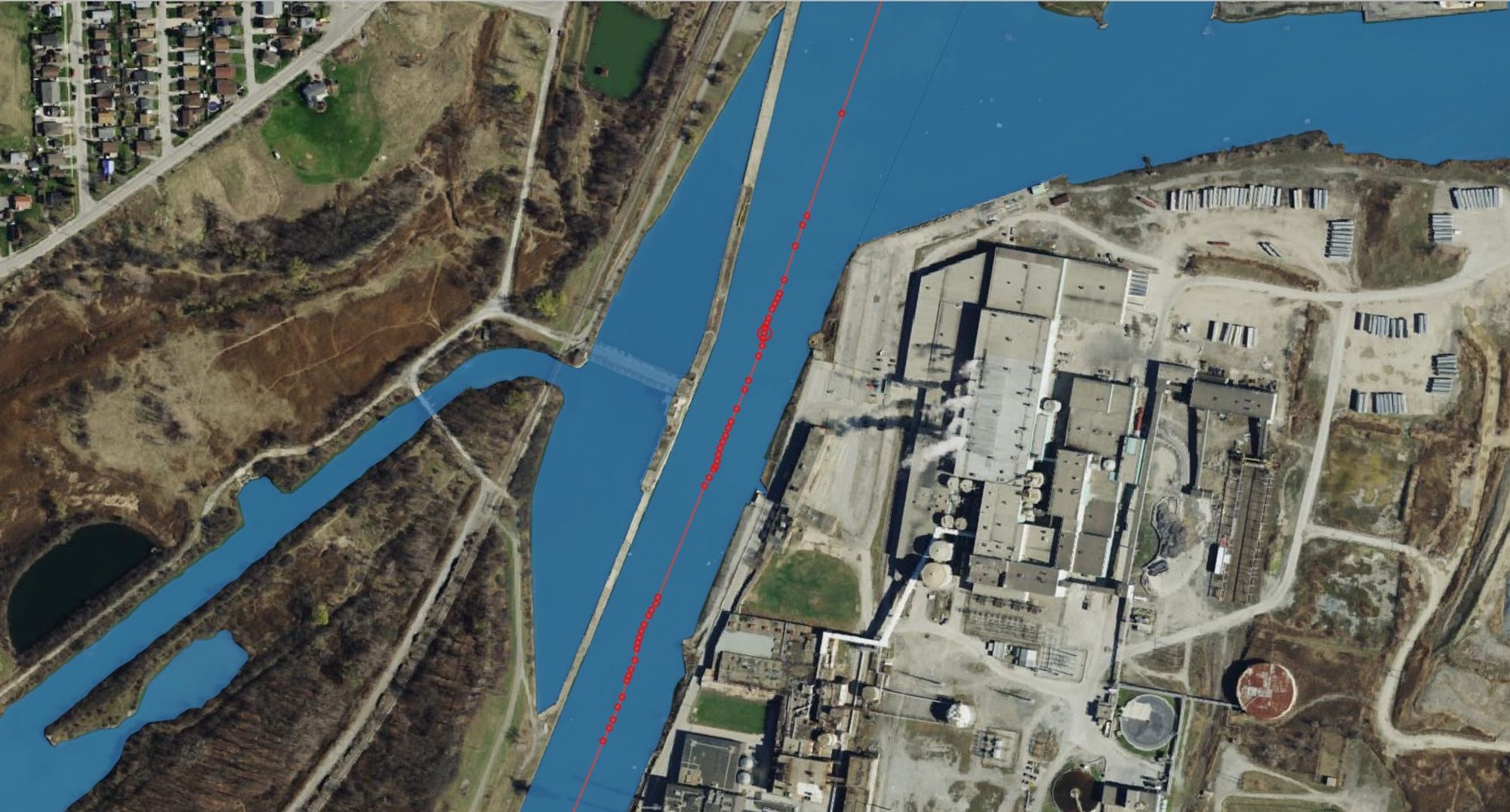 A skeleton / medial axis along a waterbody polygon in QGIS.