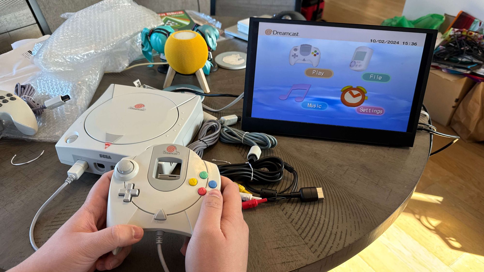 A photo of a Dreamcast plugged in to a portable monitor