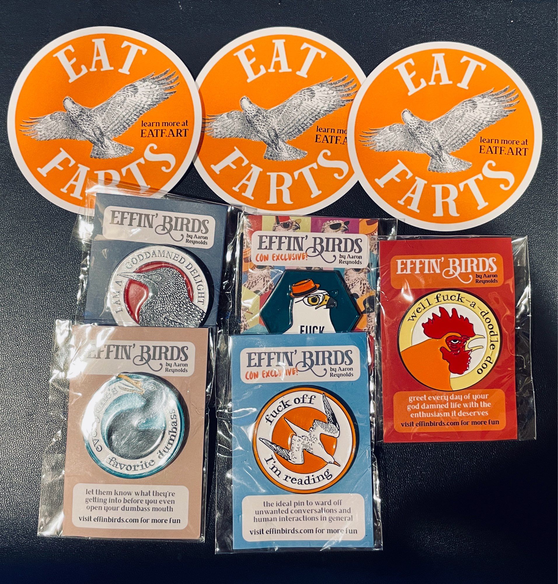 A panoply of Effin’ Birds (five pins) and 3 “Eat Farts” stickers