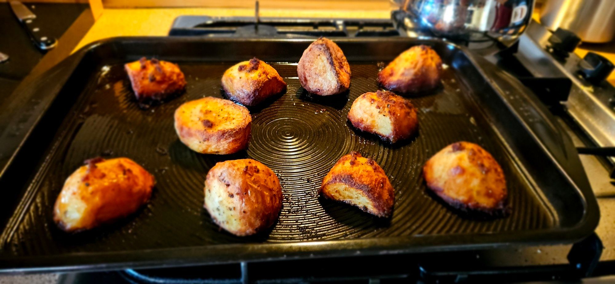 A tray of unfeasibly brown roast potatoes