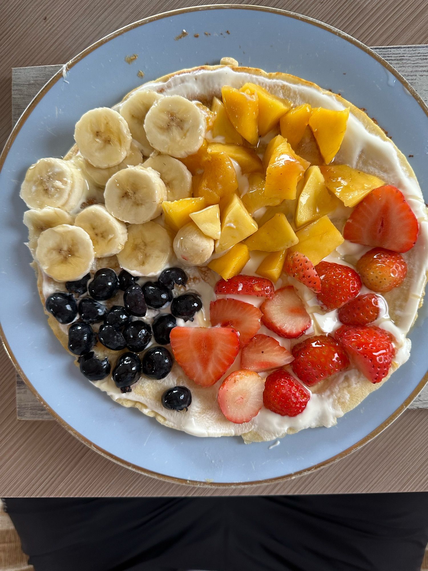 Pancake with fruit arranged in the shape of a pie chart