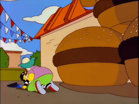 Krusty the Clown assaults a man dressed up as a robber next to inflatable hamburgers