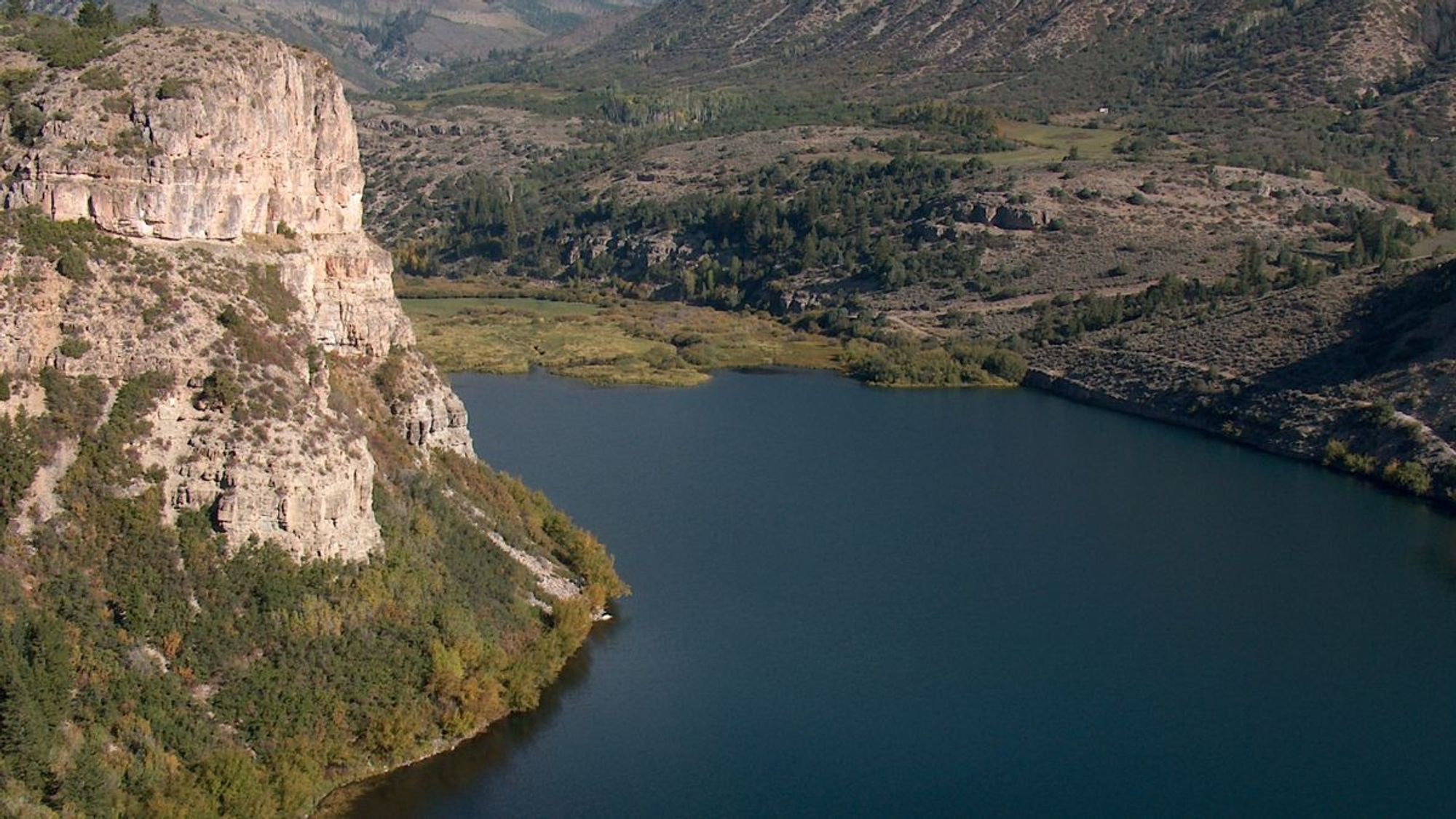 View of Colorado's Sweetwater Lake north of Dotsero. High limestone and quartzite cliffs line the lake's southern shore.