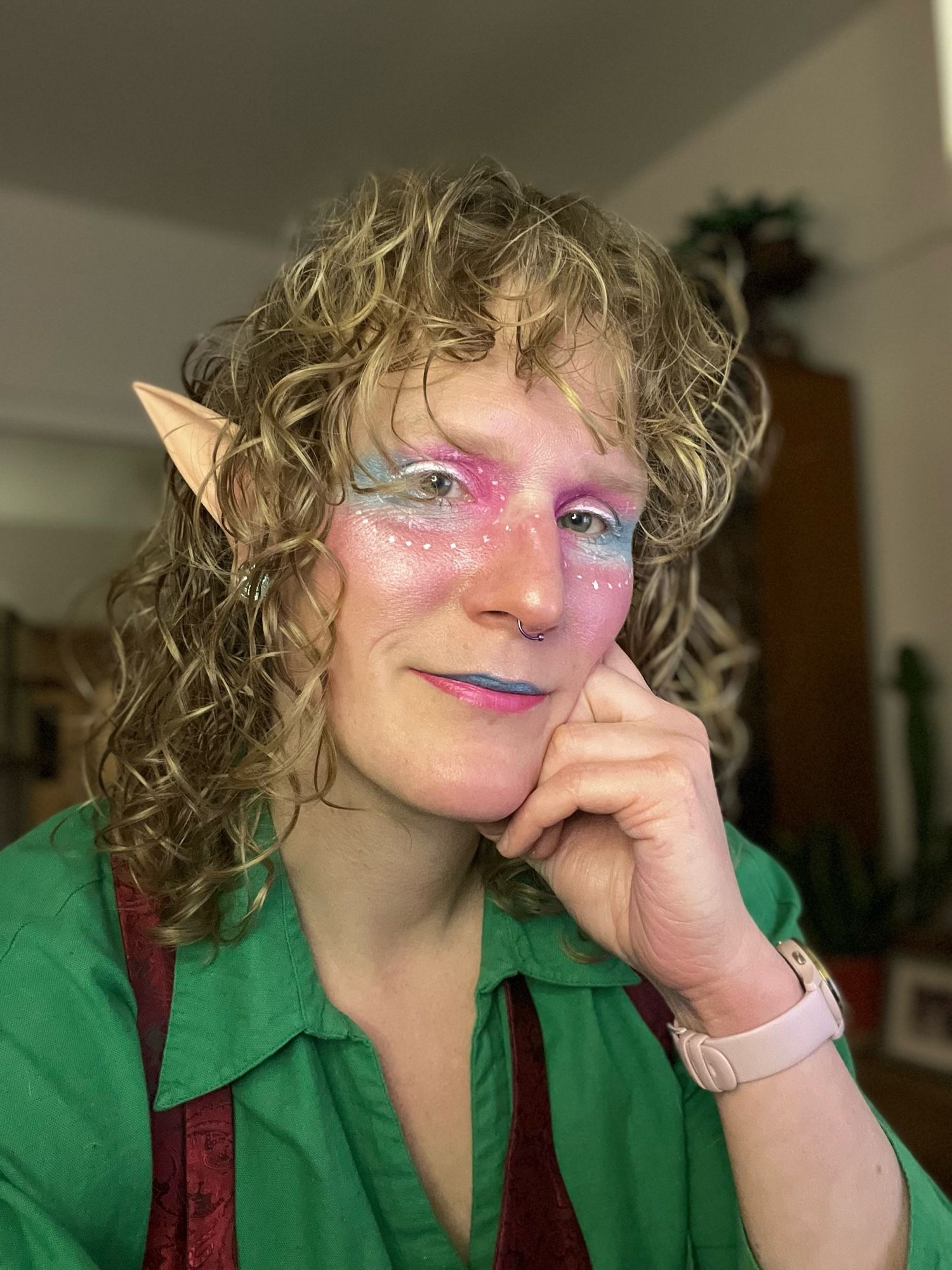 Huld in fairy makeup smiling at the viewer.