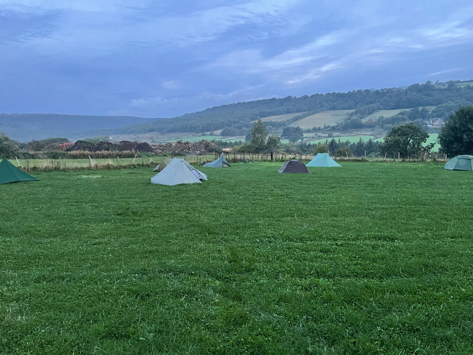 Seven pitched tents at the campsite in the Rivelin Valley.