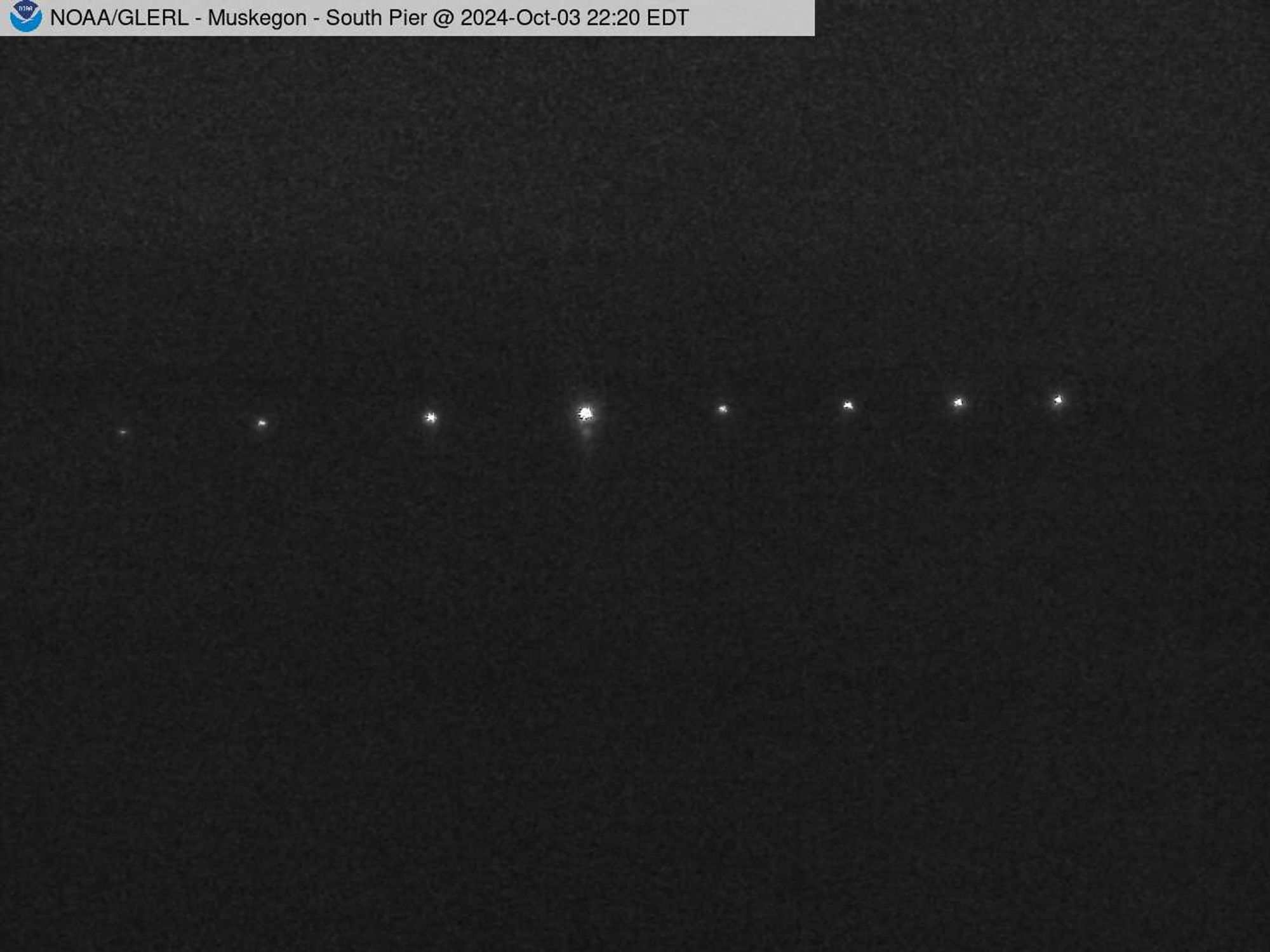 Wide view of the Muskegon channel southern breakwater stretching into Lake Michigan. // Image captured at: 2024-10-04 02:20:01 UTC (about 13 min. prior to this post) // Current Temp in Muskegon: 56.84 F | 13.80 C // Precip: clear sky // Wind: NE at 7.493 mph | 12.06 kph // Humidity: 75%