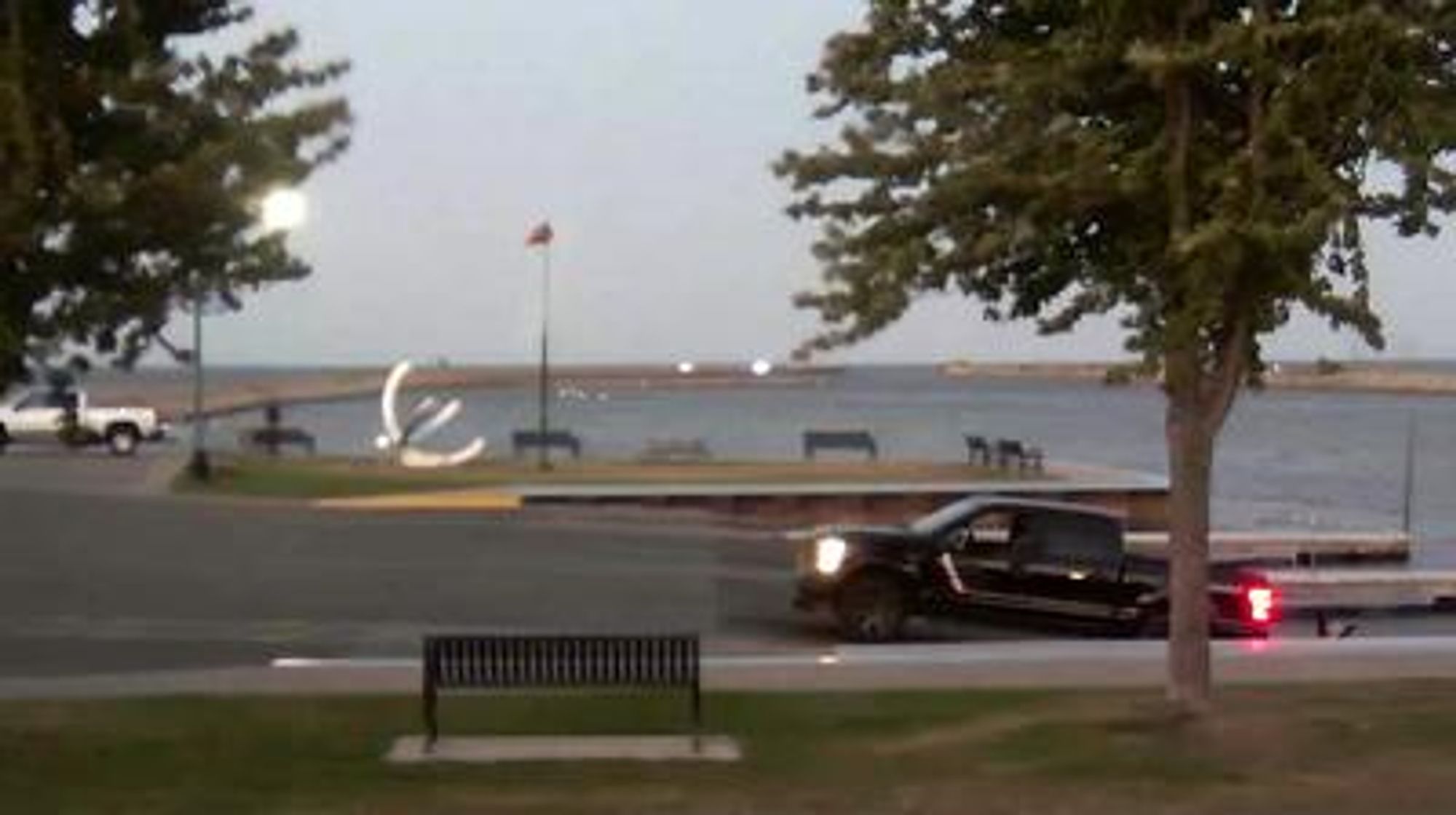 View looking northeast of the Oconto boat ramp and windsock in the foreground, with the breakwaters stretching into Sturgeon Bay behind it. // Image captured at: 2024-10-02 23:46:38 UTC (about 18 min. prior to this post) // Current Temp in Oconto: 64.49 F | 18.05 C // Precip: clear sky // Wind: SSW at 9.216 mph | 14.83 kph // Humidity: 29%