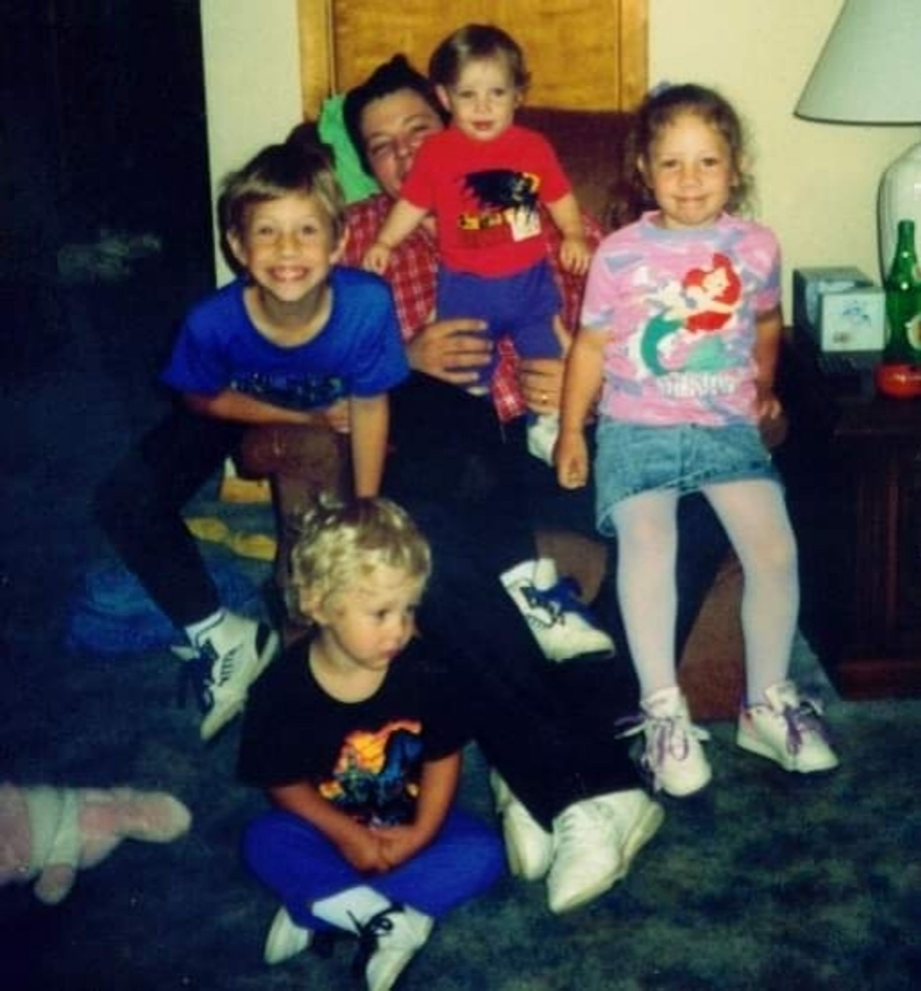 An old picture of myself and my three brothers as kids sitting with our dad.