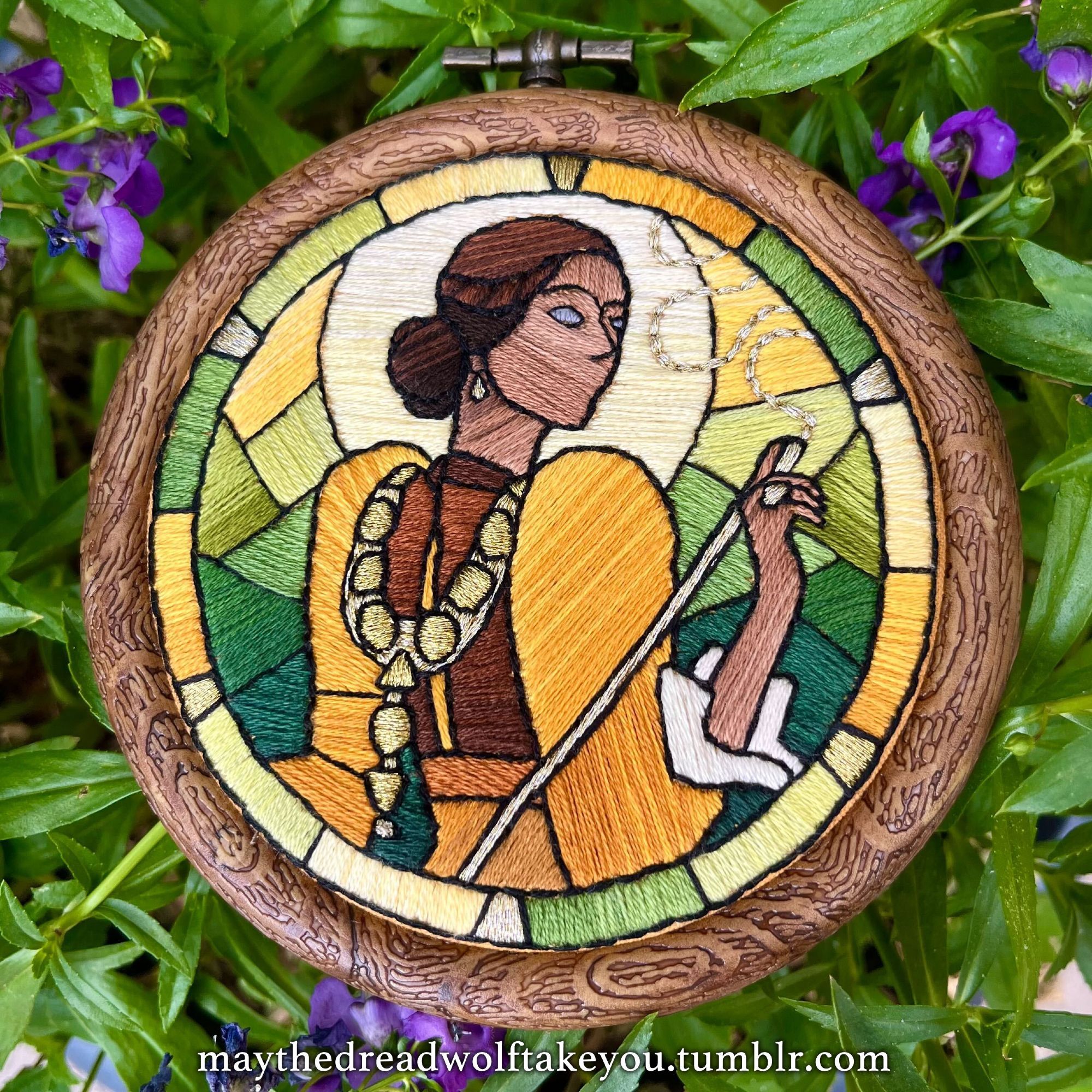 Circular embroidery of Josephine from the Dragon Age games made to look like faux stained glass